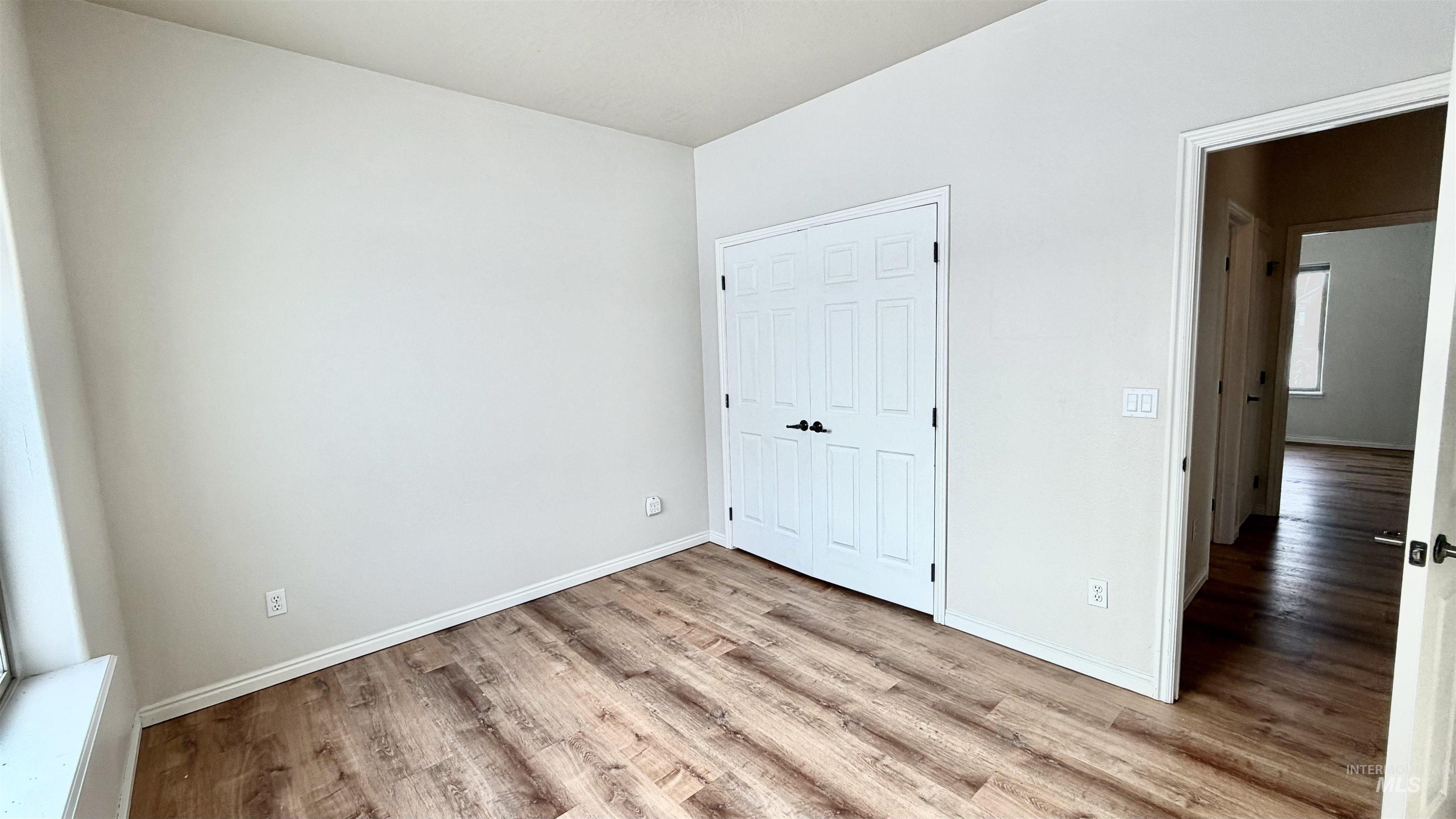 Unfurnished bedroom featuring light wood-type flooring and a closet