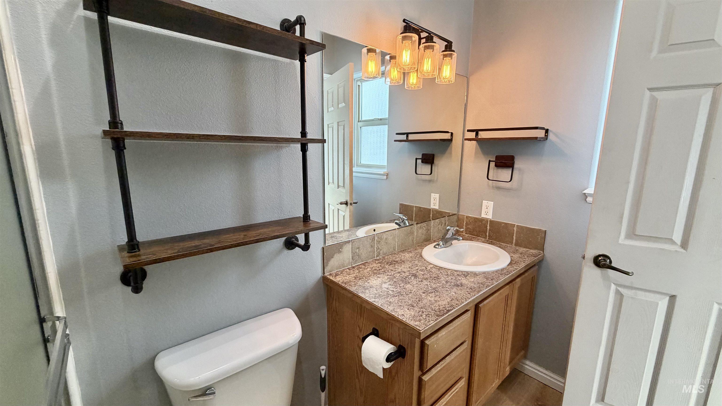 Half bath featuring vanity and toilet