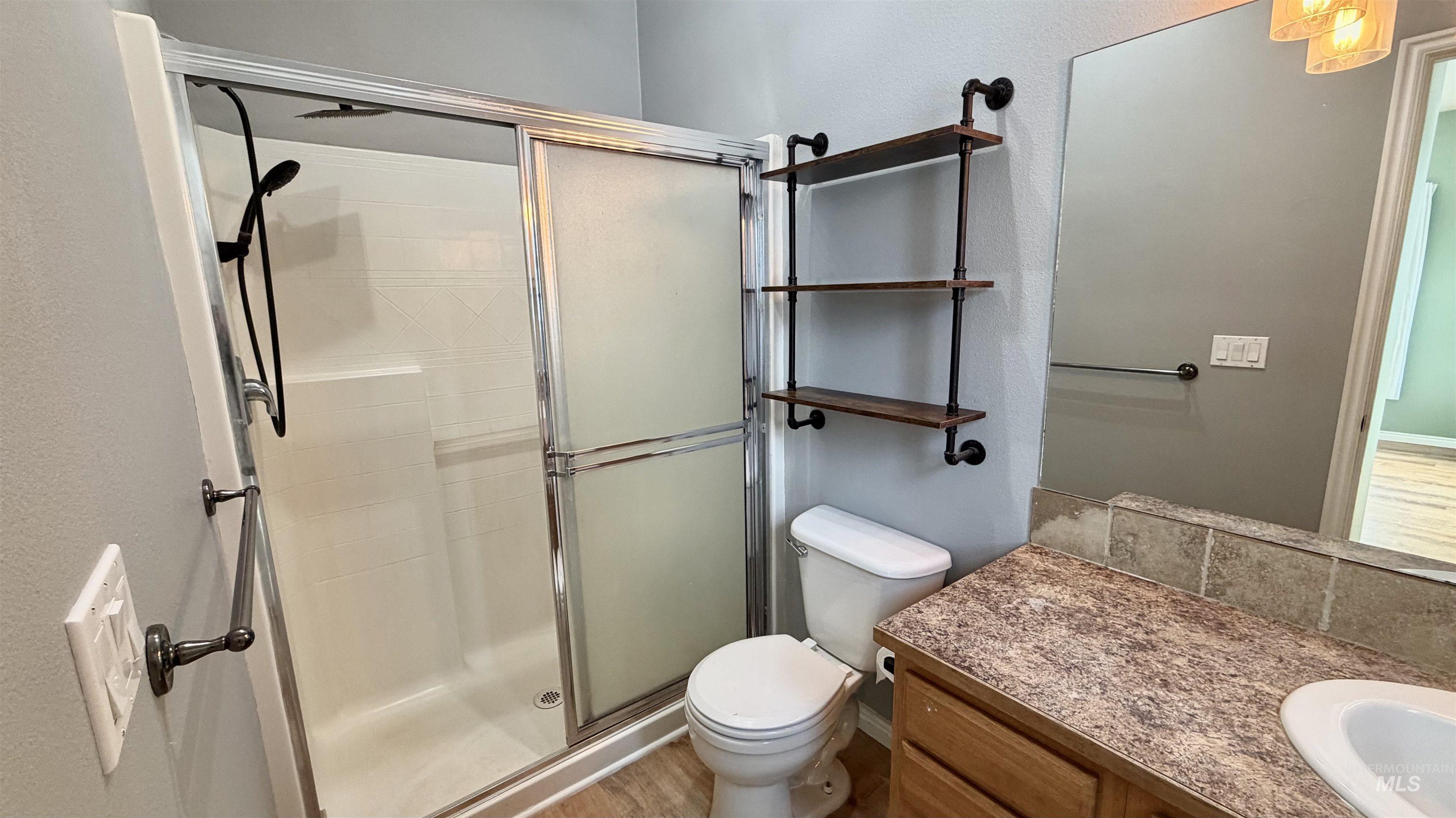Bathroom featuring a stall shower and vanity
