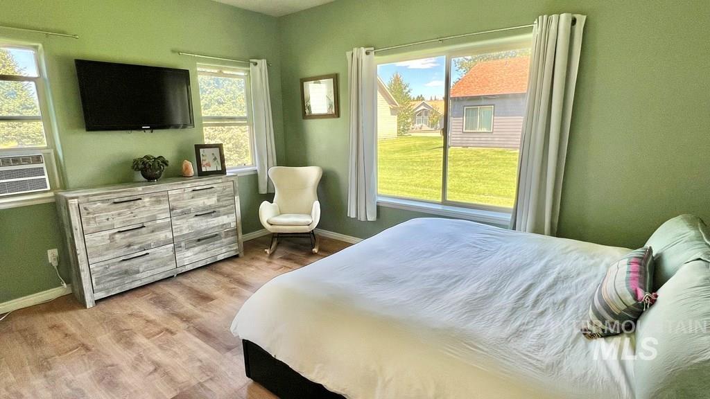 Bedroom with baseboards and light wood-type flooring