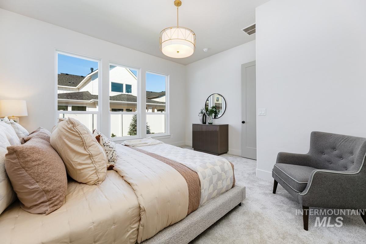 Bedroom with light carpet and baseboards