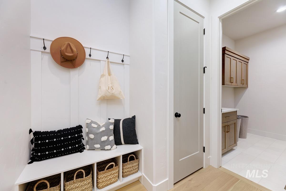 Mudroom with light wood finished floors and baseboards