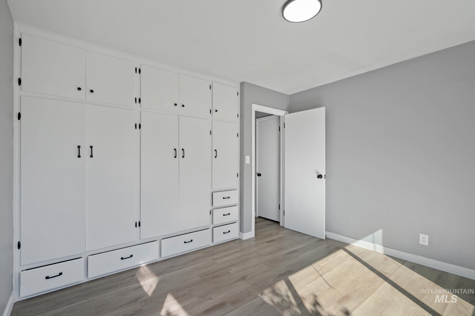 Unfurnished bedroom featuring a closet and light wood-type flooring