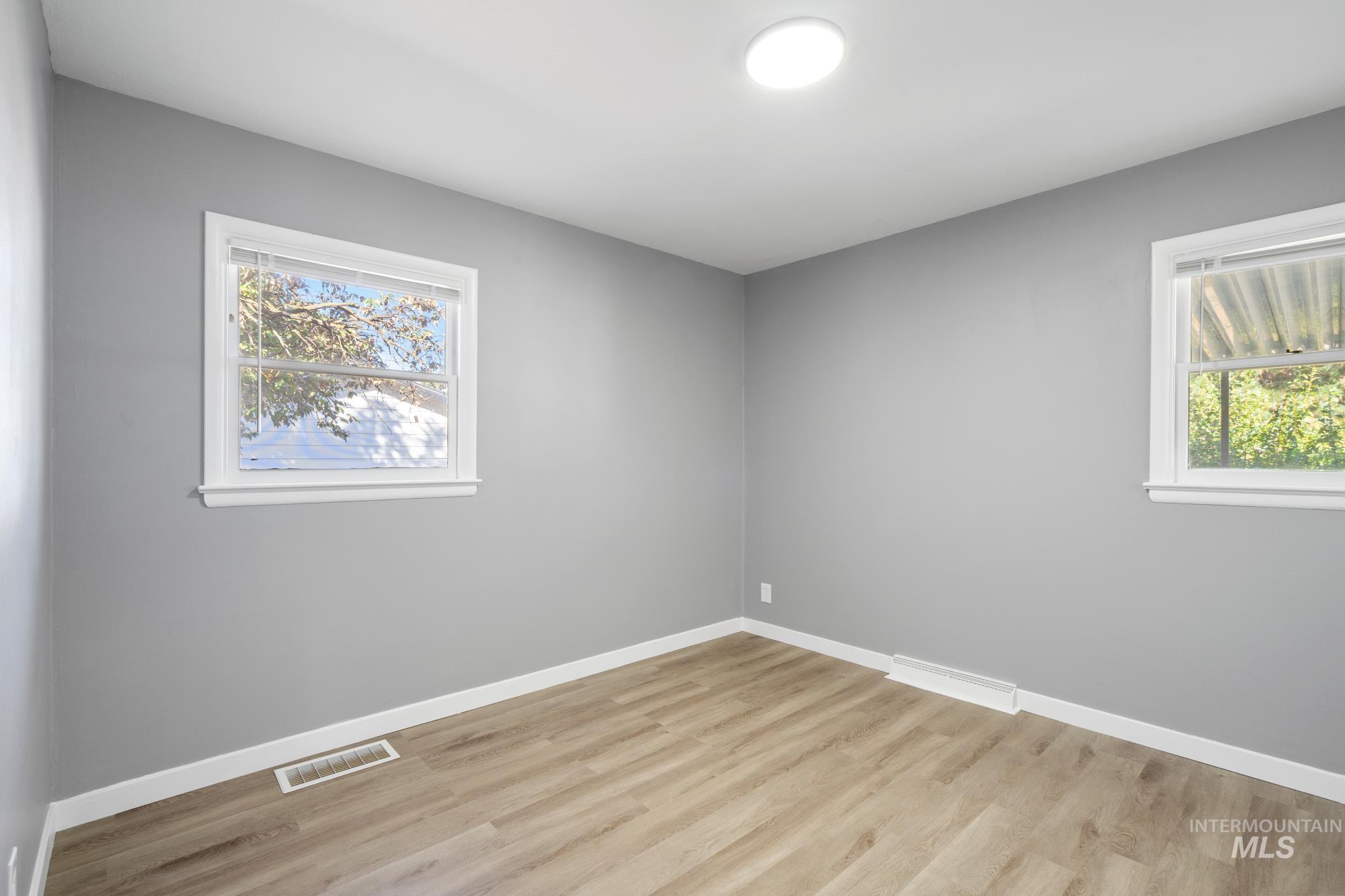 Unfurnished room with light wood-type flooring