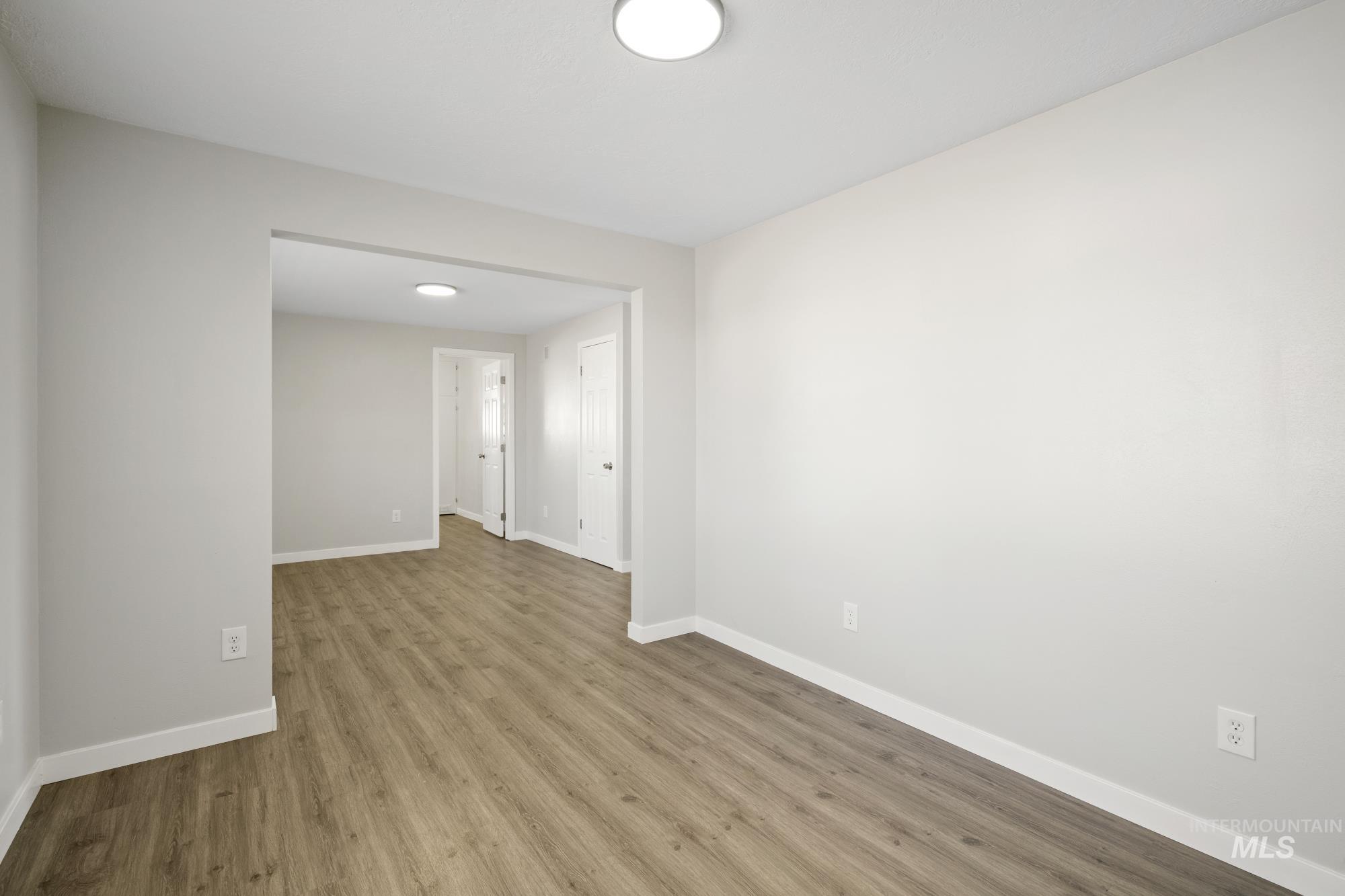 Empty room with wood finished floors and baseboards