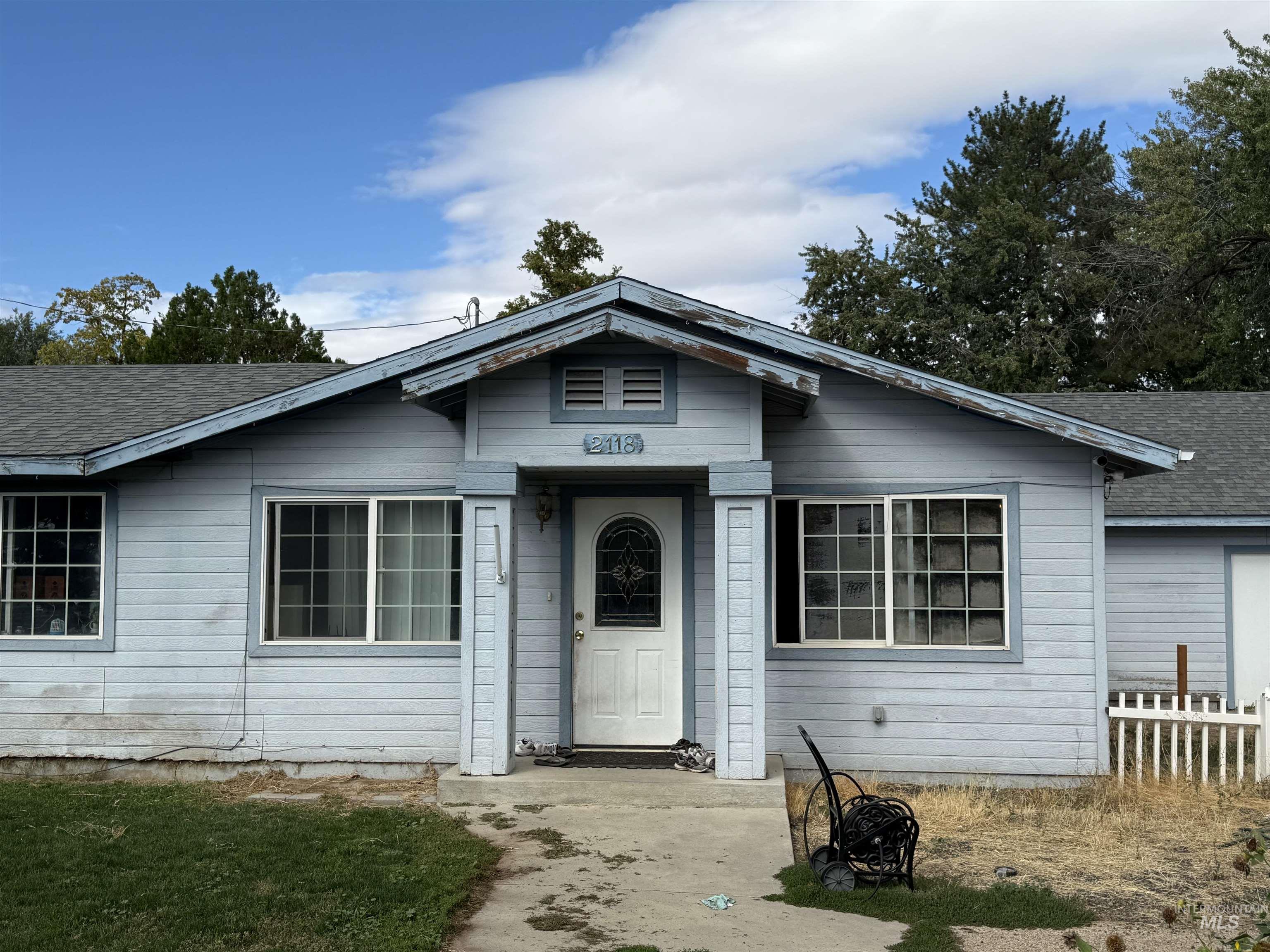 View of front of house featuring roof with shingles