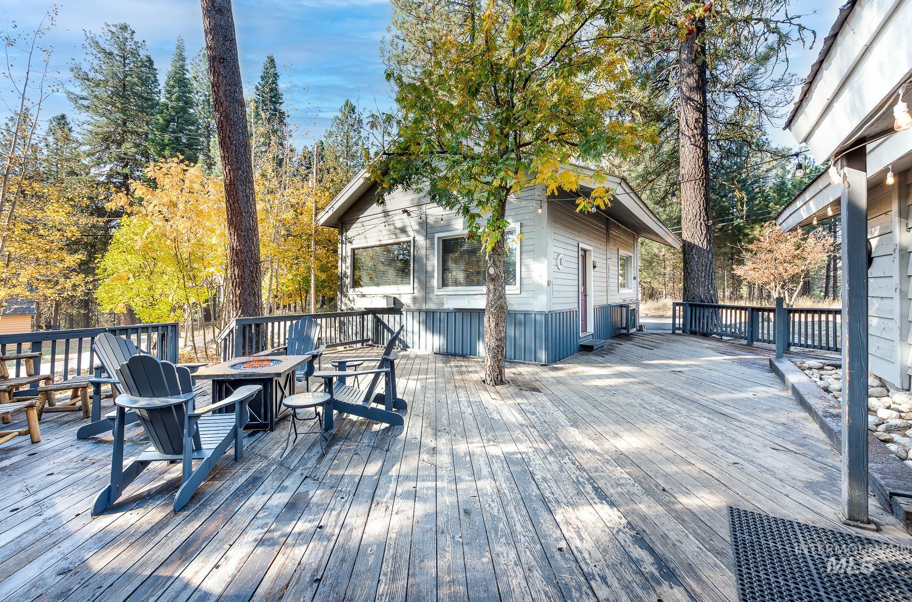Wooden terrace featuring an outdoor fire pit