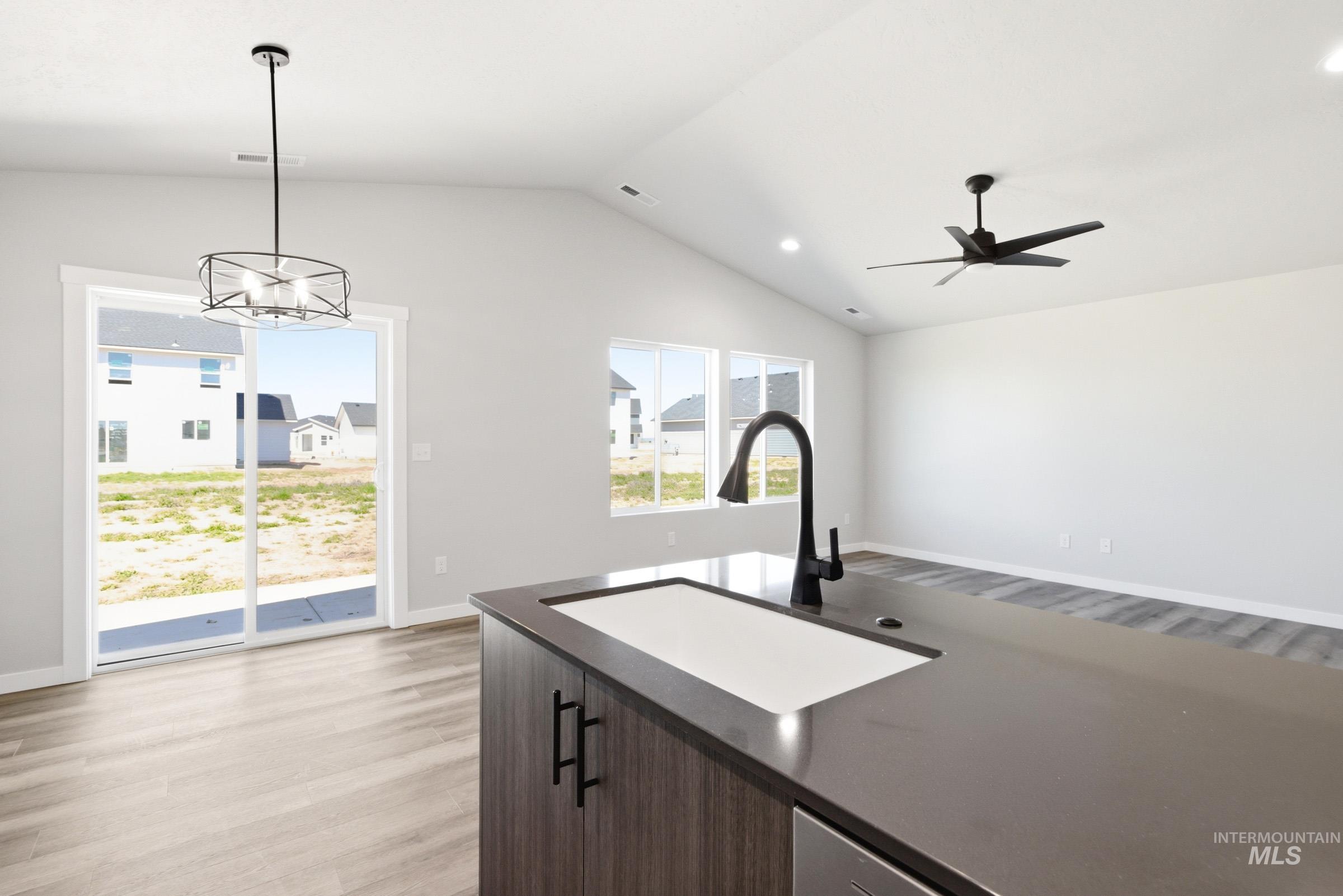 Kitchen island featuring an undermount sink with a matte black gooseneck faucet