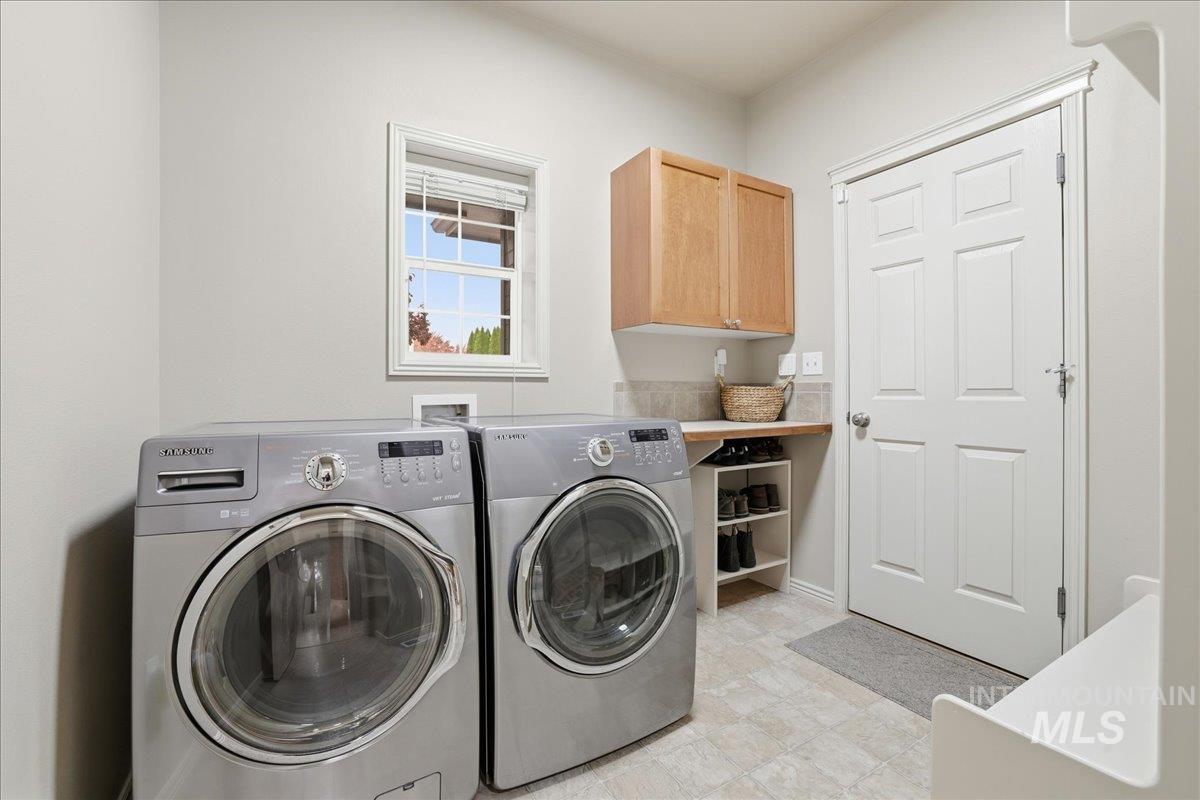 Laundry area with independent washer and dryer and cabinet space