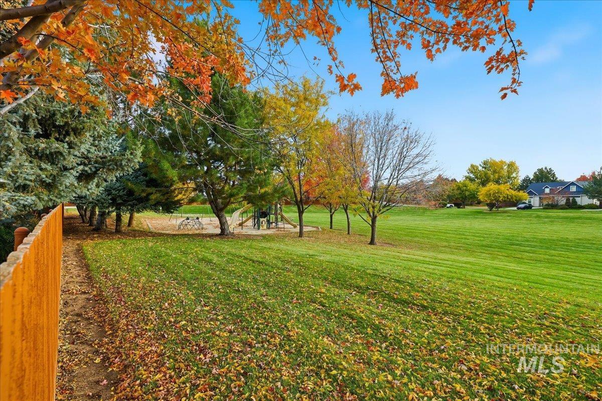 View of grassy yard featuring a playground