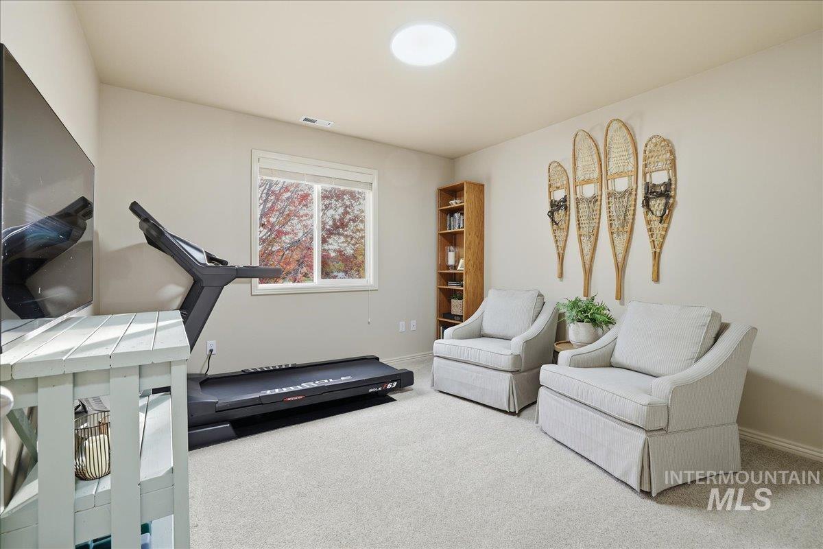 Exercise area featuring carpet and baseboards