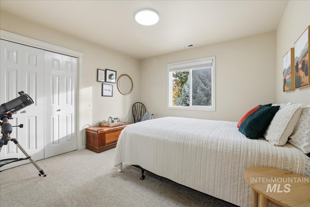 Carpeted bedroom with a closet
