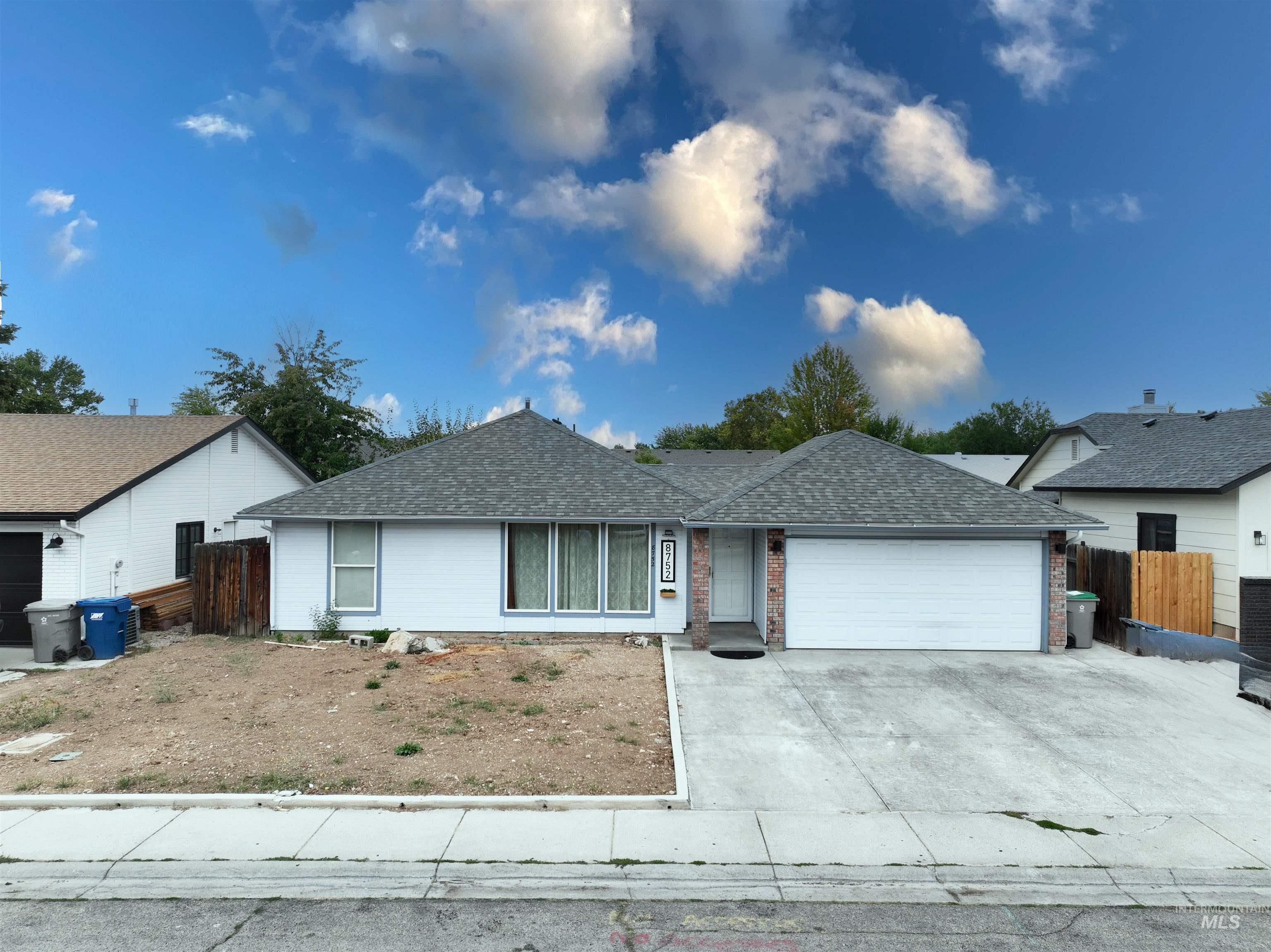 Single story home with roof with shingles, driveway, and an attached garage