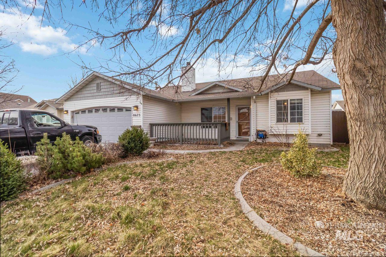 Ranch-style home featuring a garage and a chimney