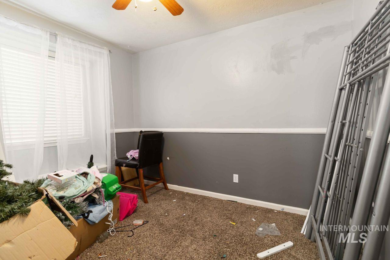 Bedroom featuring dark carpet and ceiling fan