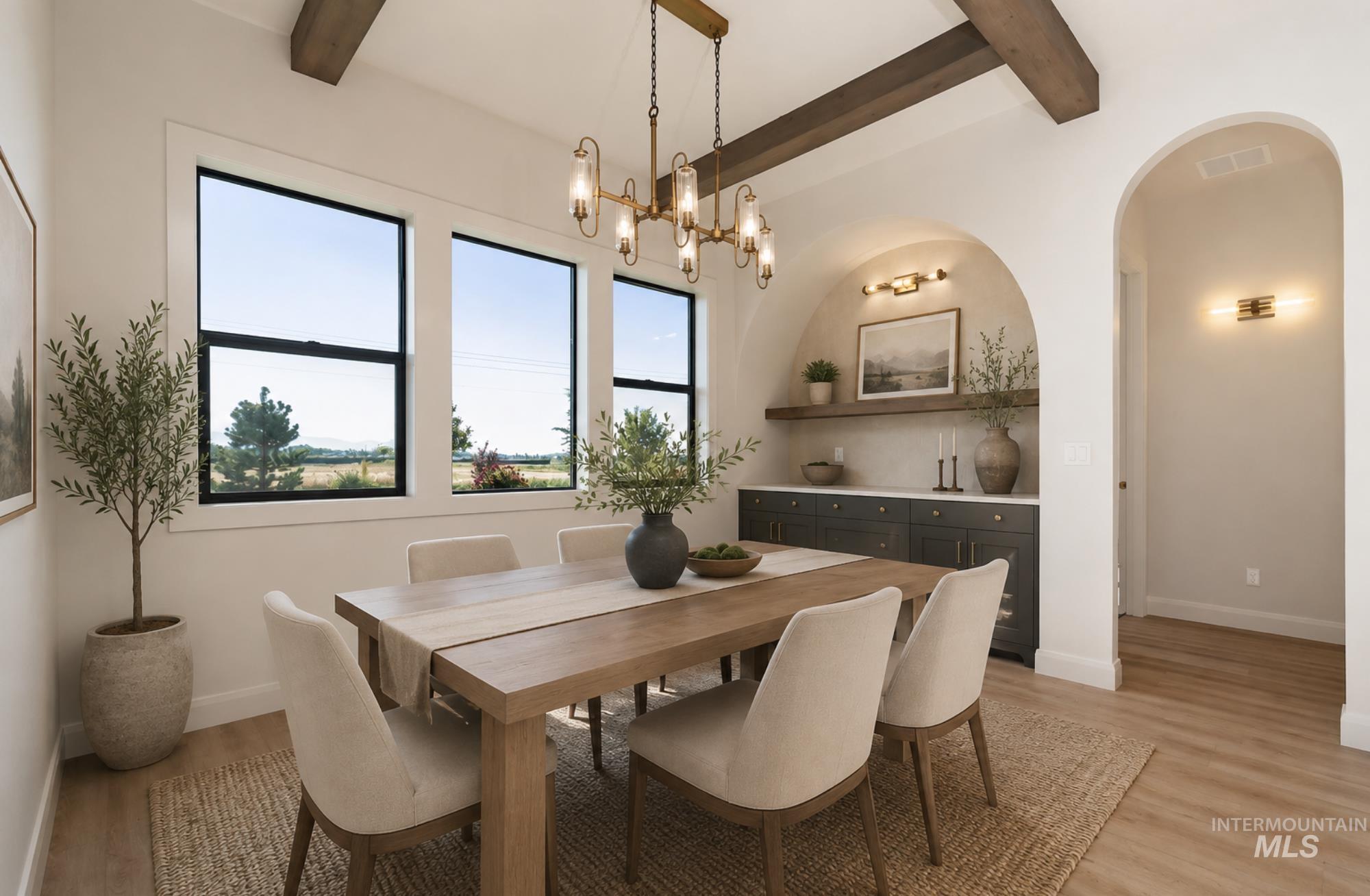 Dining area featuring wood-finish flooring, exposed ceiling beams, and a modern chandelier