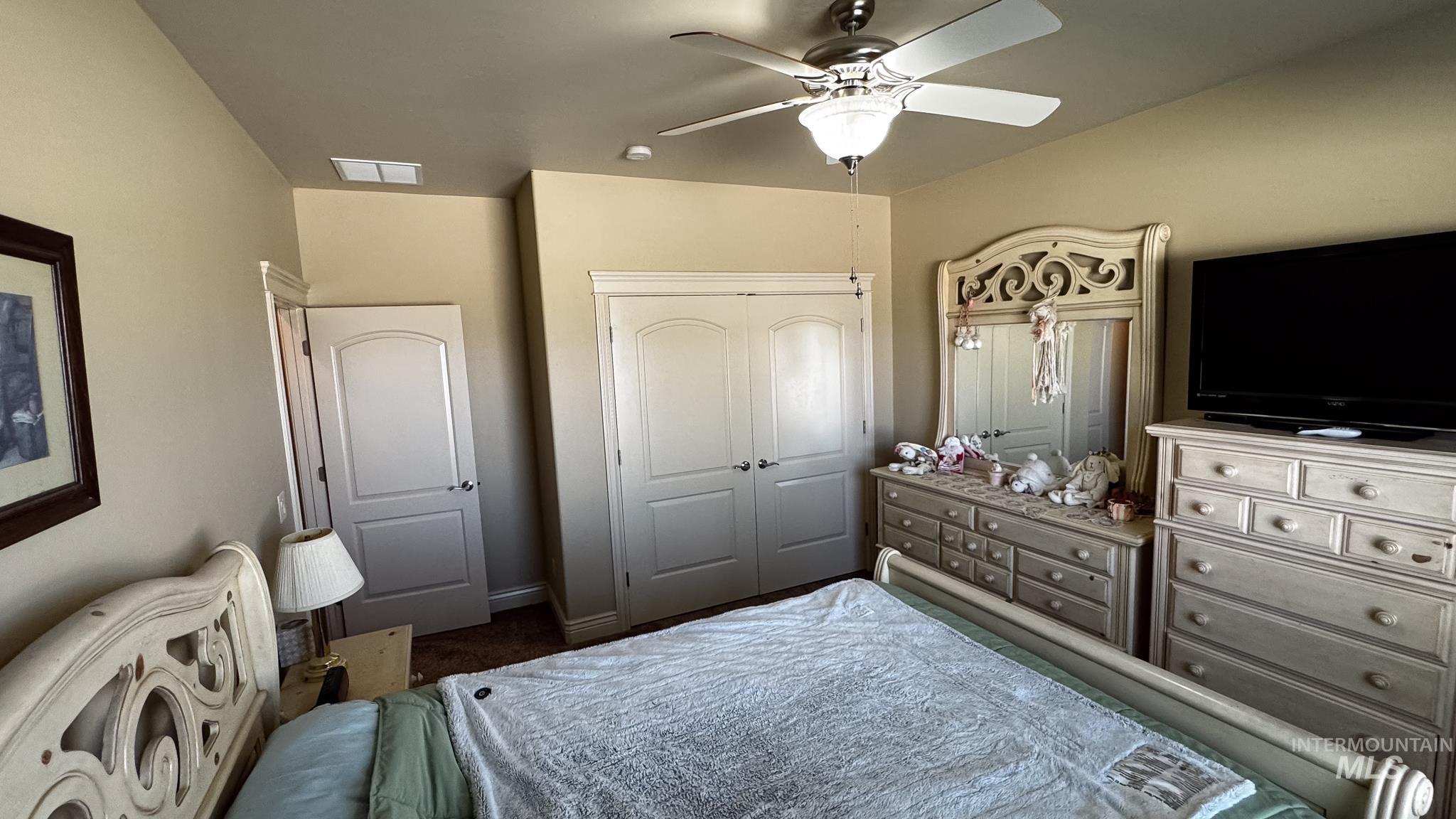 Bedroom with a closet and a ceiling fan
