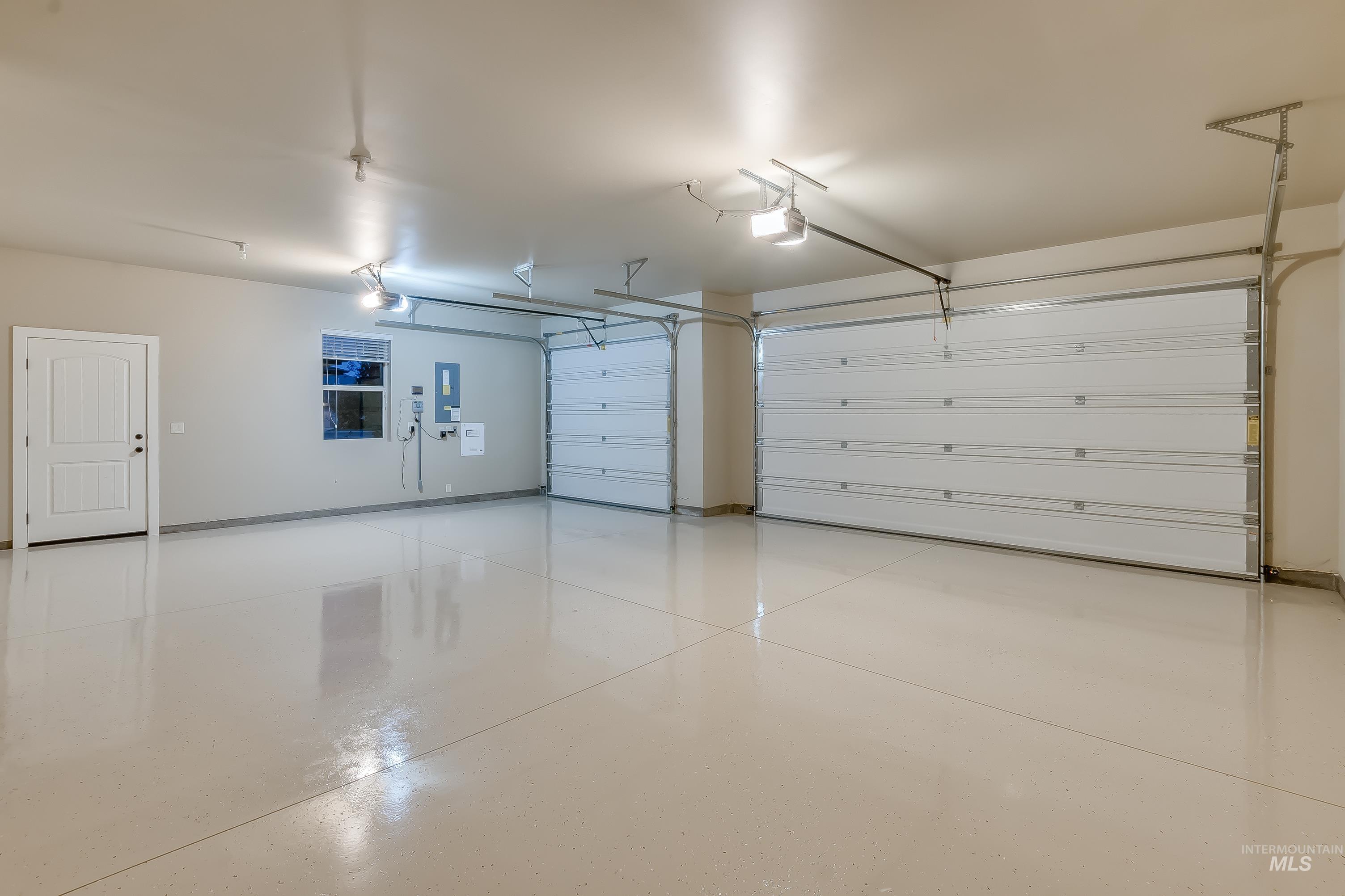 Garage with electric panel and a garage door opener