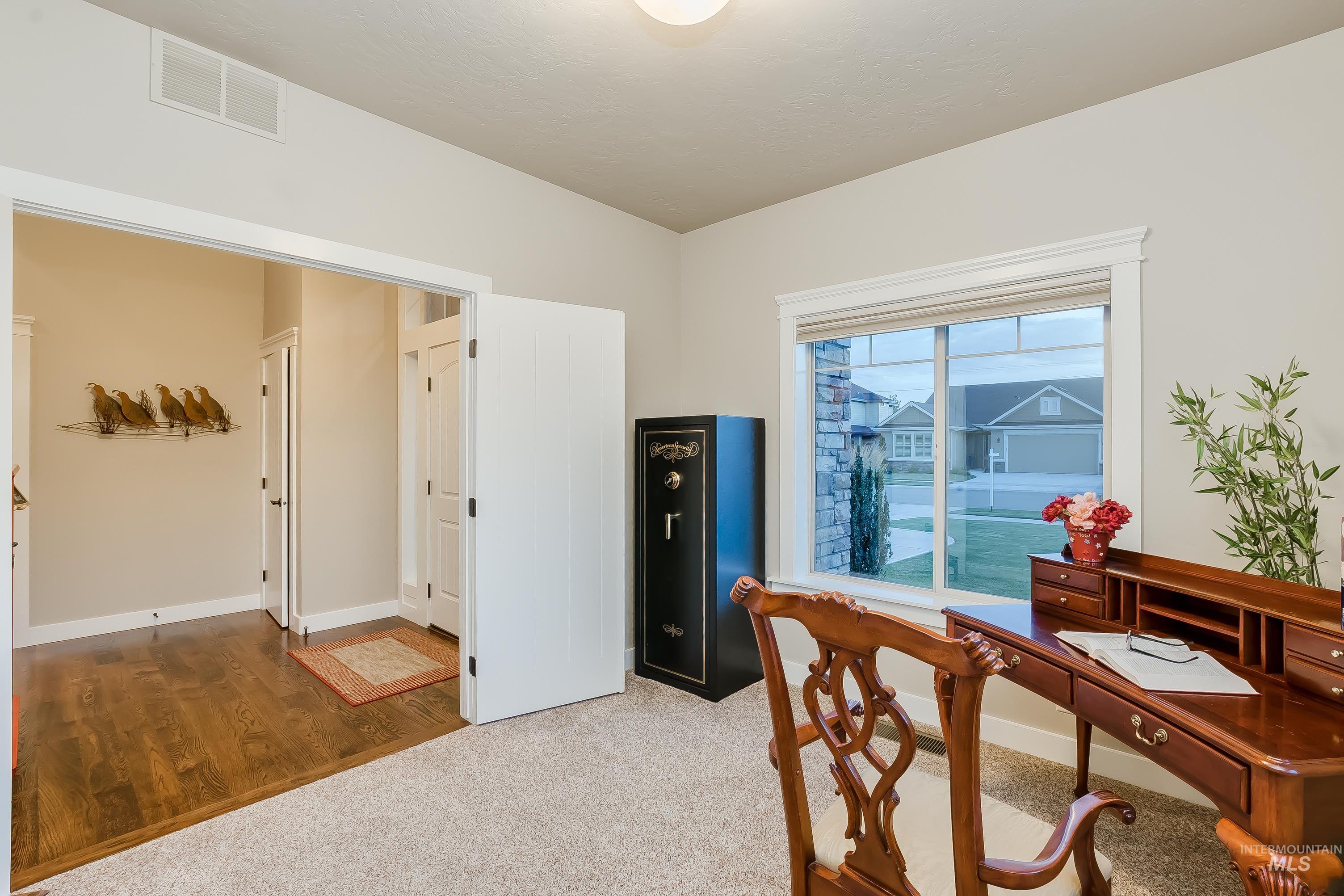 Home office with carpet floors and wood finished floors