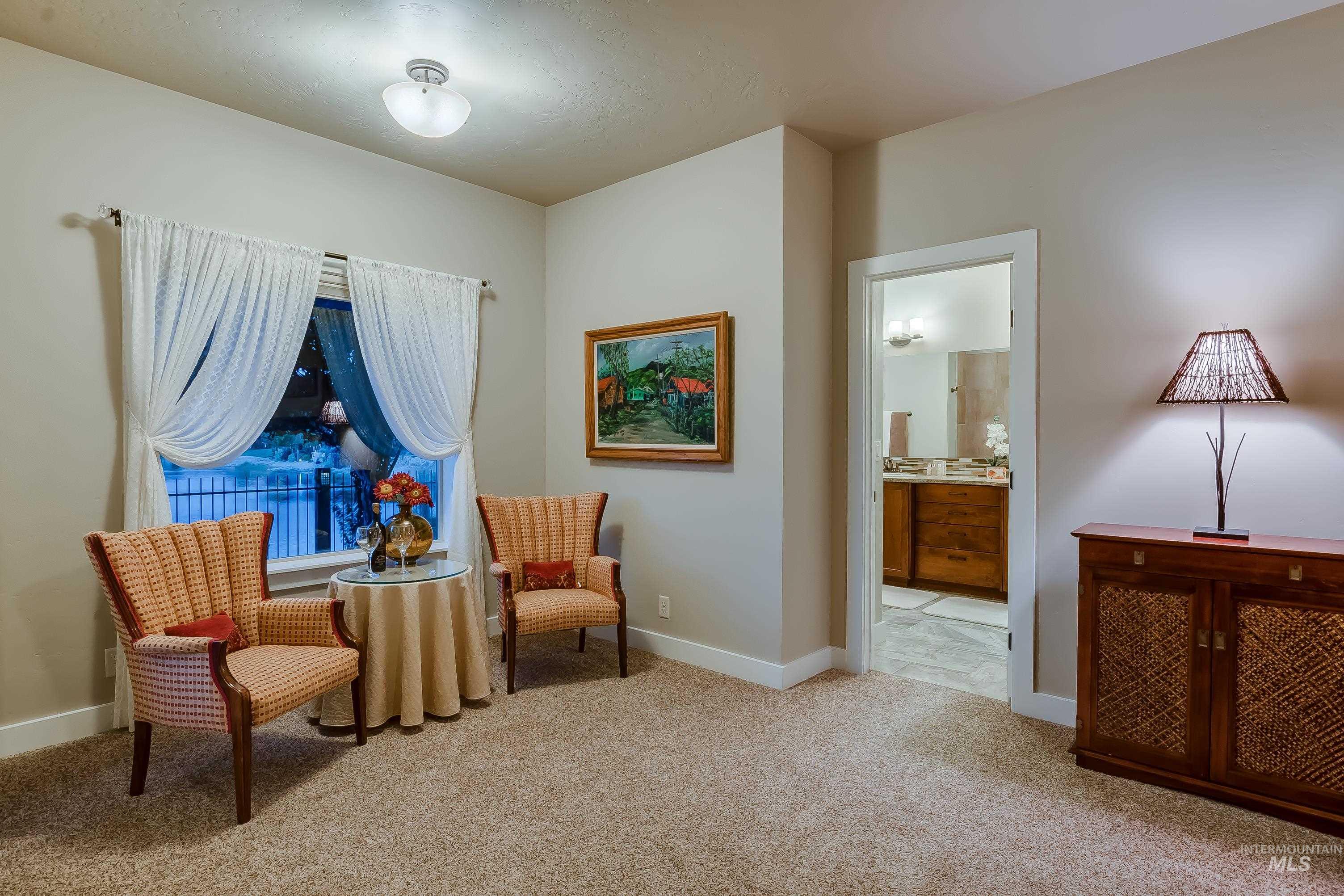 Sitting room featuring light carpet and baseboards