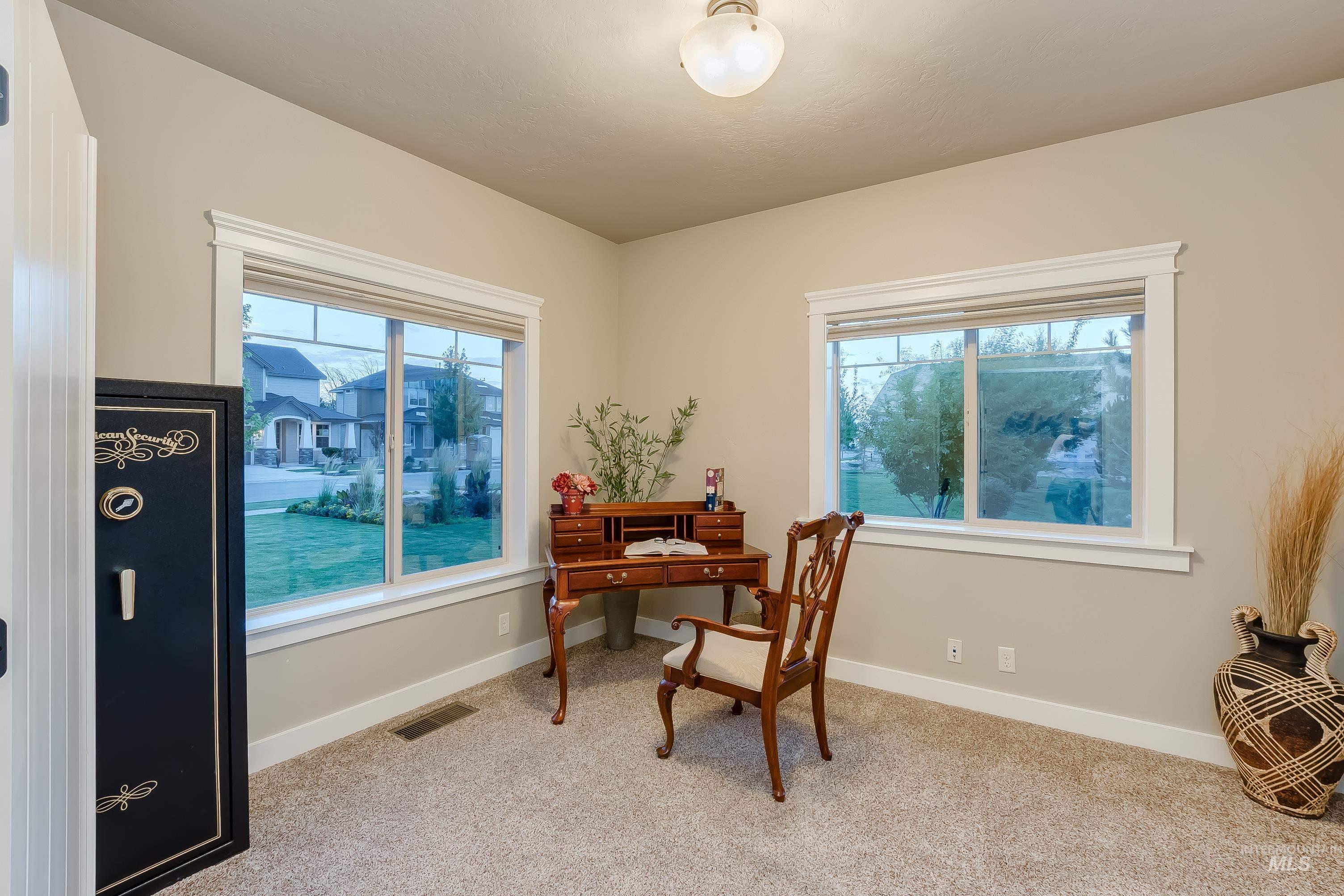 Home office featuring baseboards and light colored carpet