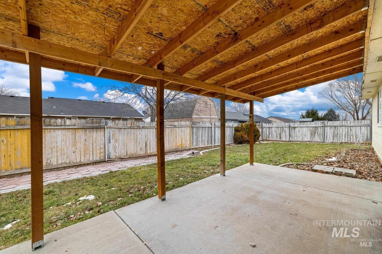 Fenced backyard with a patio area
