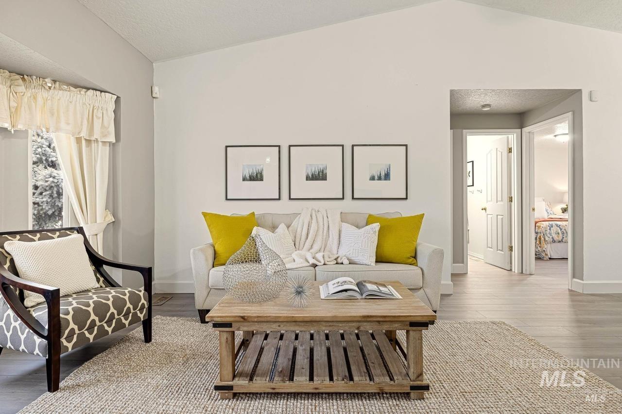 Living area featuring vaulted ceiling and wood finished floors