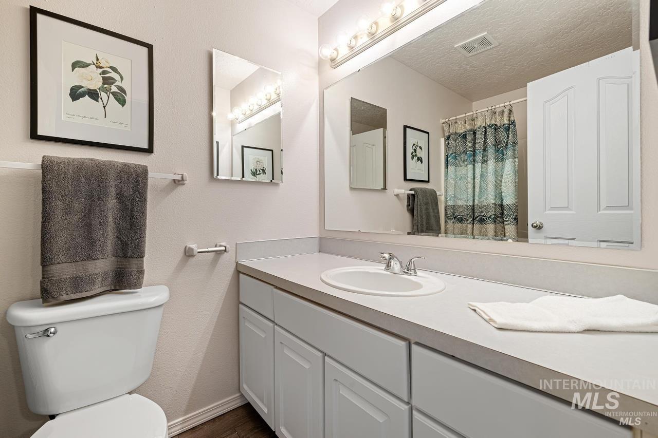 Bathroom featuring vanity and wood finished floors