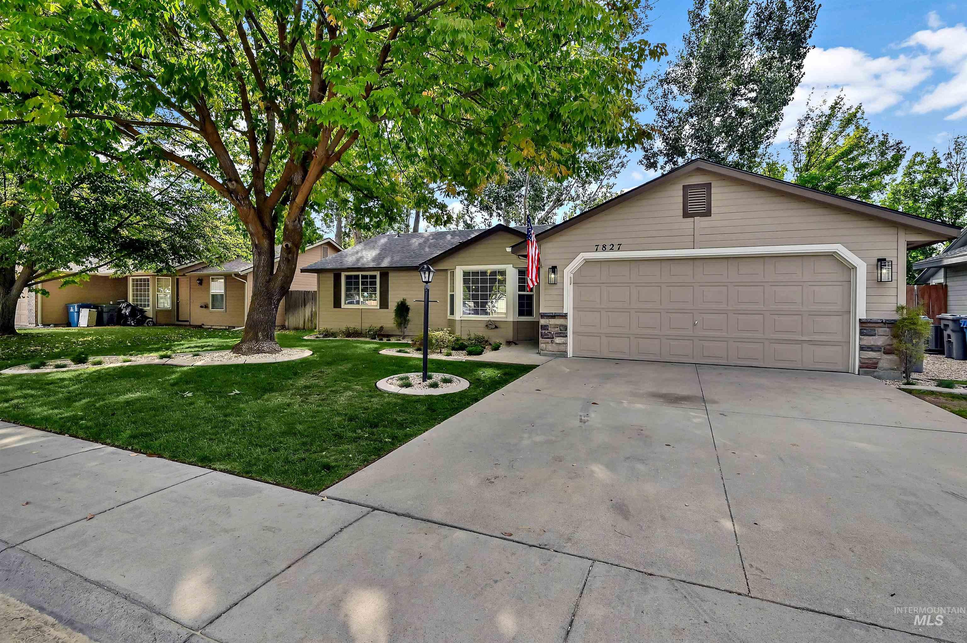 Ranch-style house featuring new and mature landscaping, an attached garage, and a brand new roof