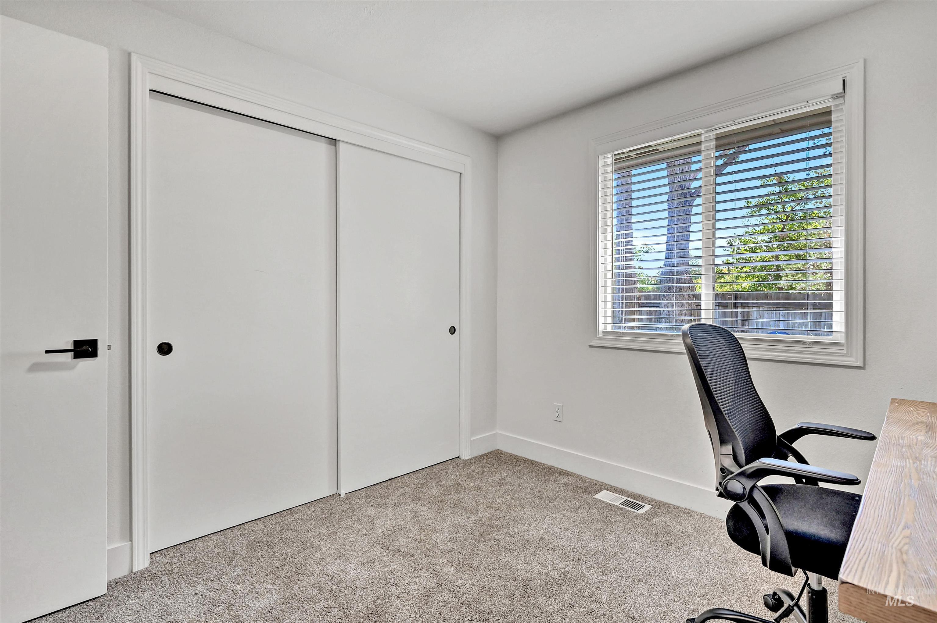 Bedroom featuring light colored carpet and a closet
