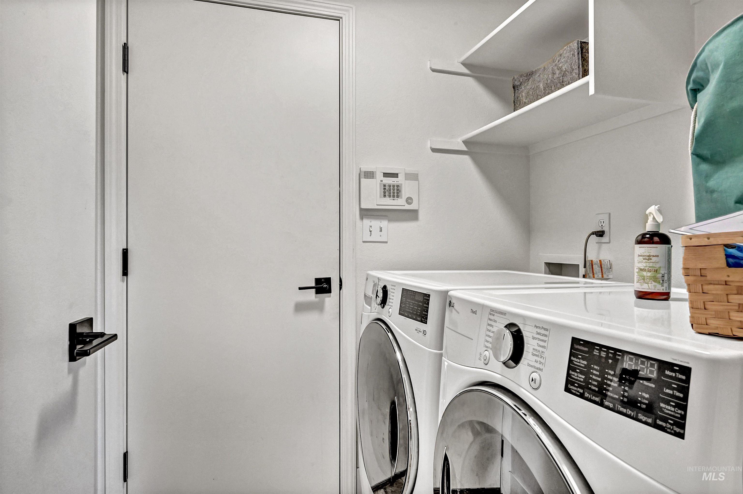 Laundry room featuring washing machine and dryer & shelves