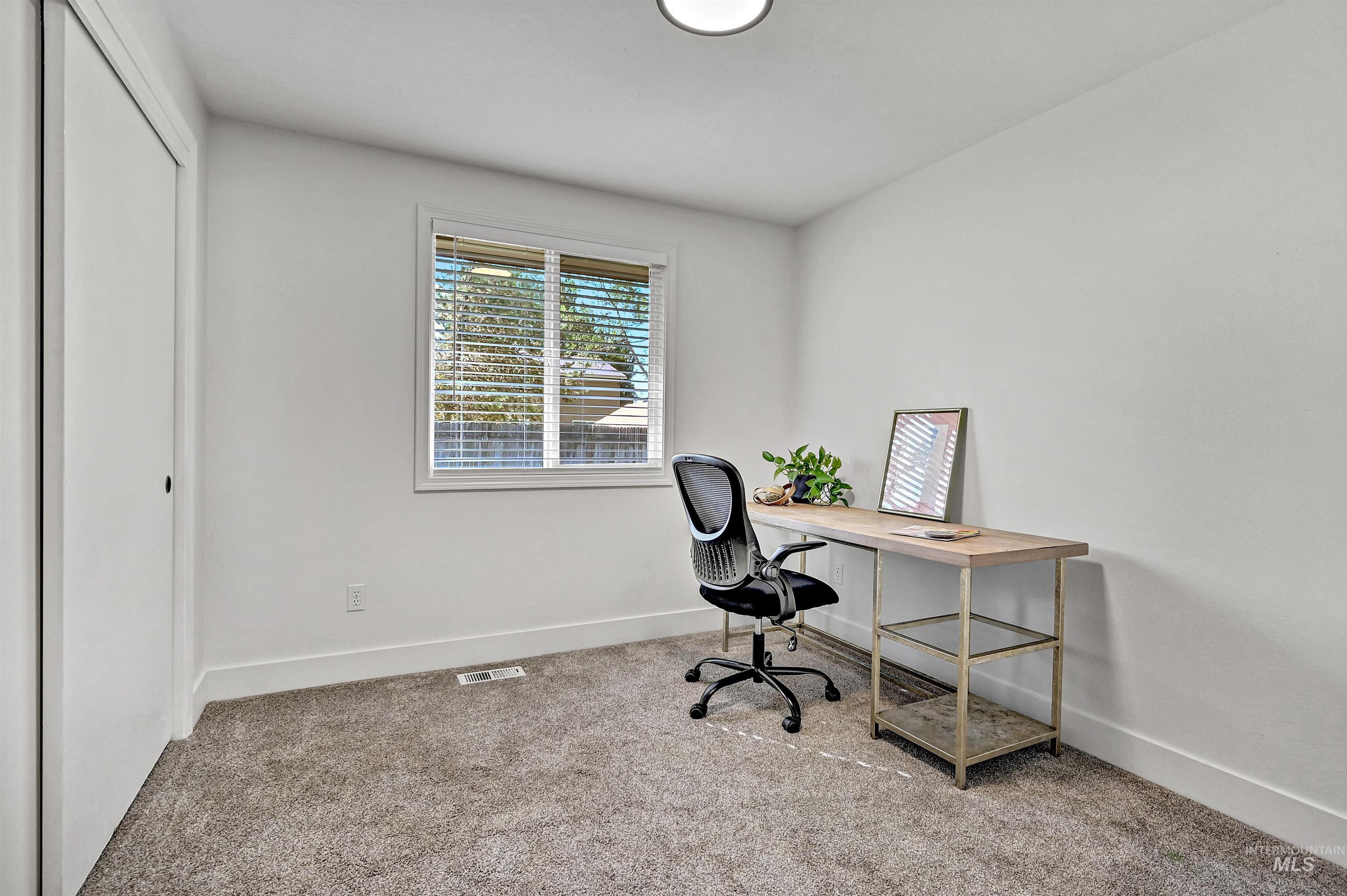 Bedroom featuring light colored carpet and a closet