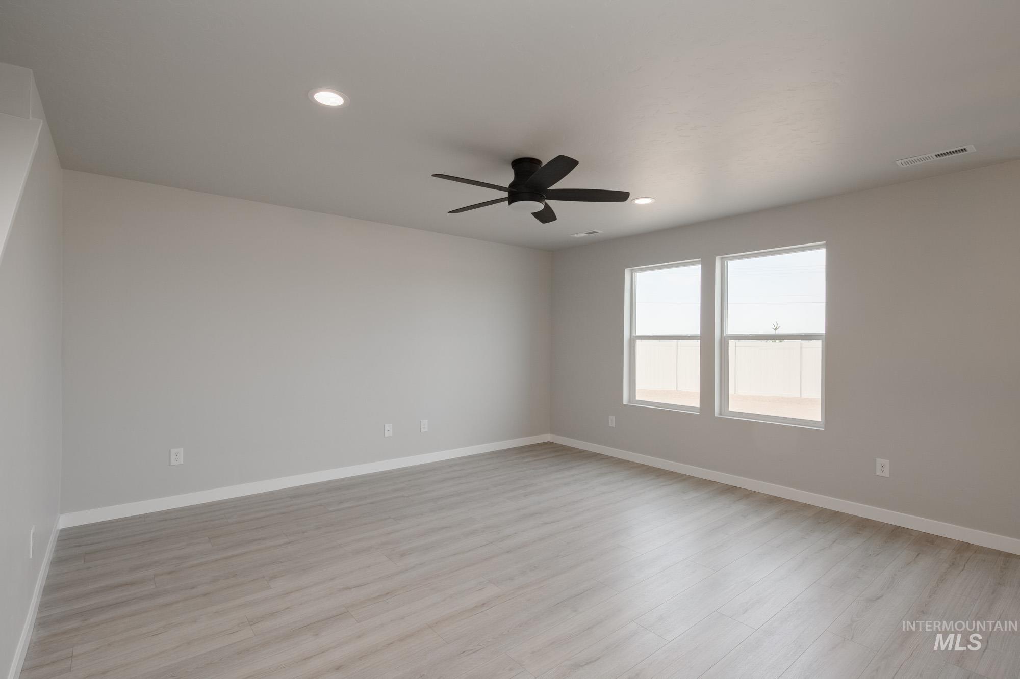 Unfurnished room with light wood-style flooring, recessed lighting, and a ceiling fan