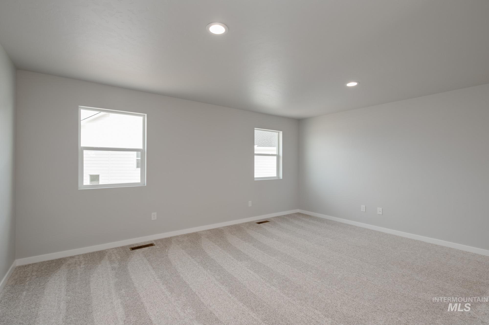 Unfurnished room with light carpet and recessed lighting