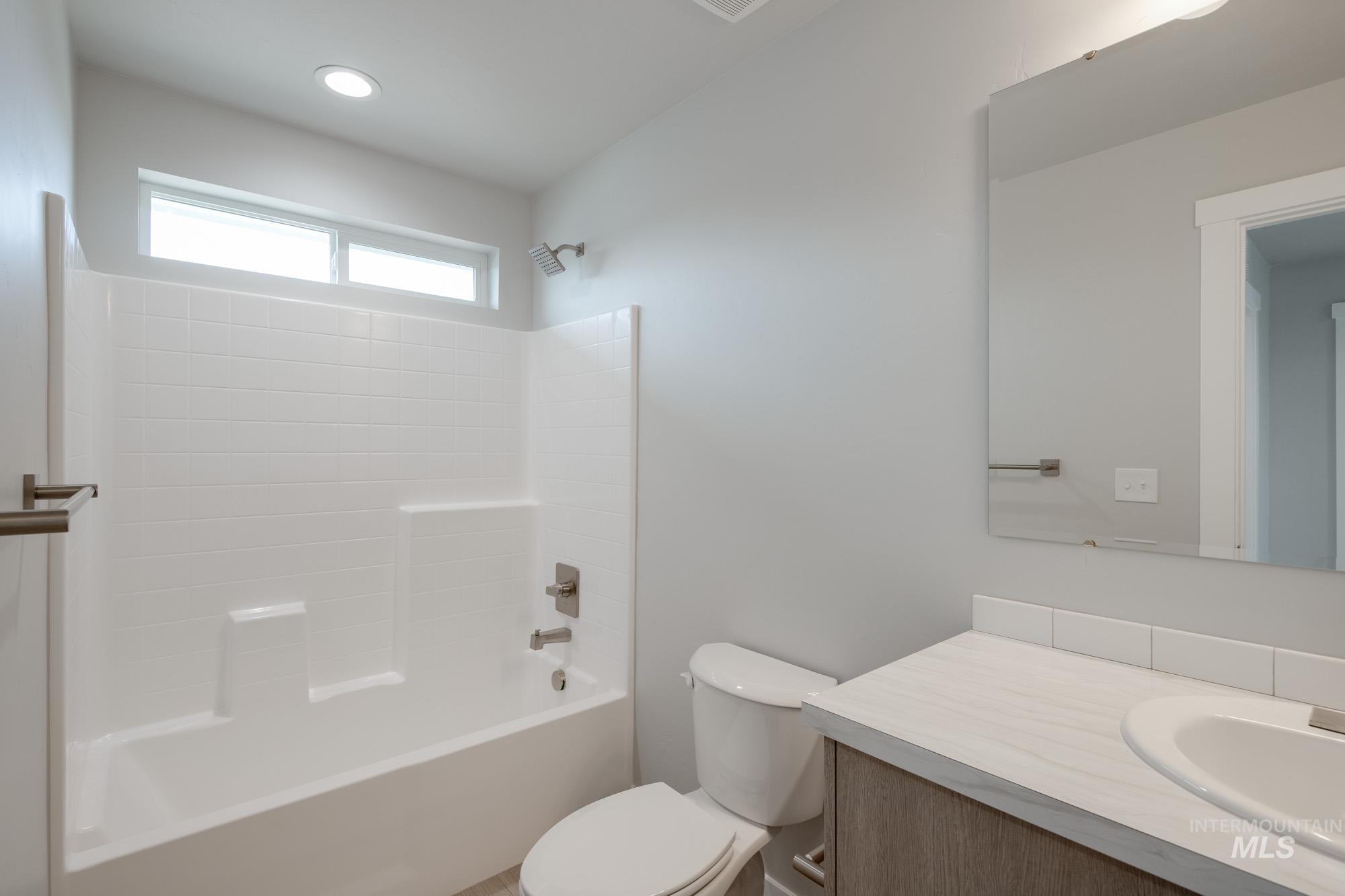 Bathroom featuring vanity and shower / tub combination