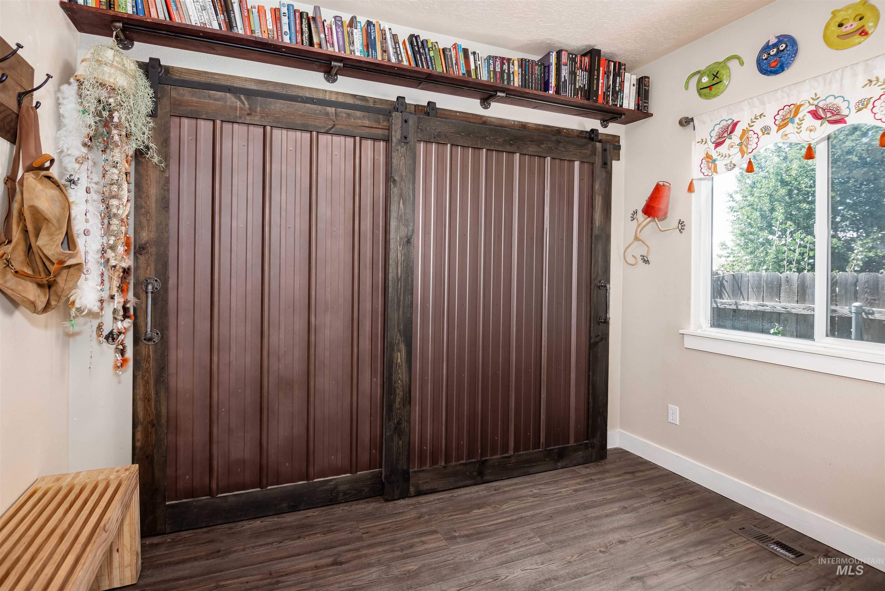 Dual barn doors with wood-finish framing and corrugated metal panels. Built ins, main level