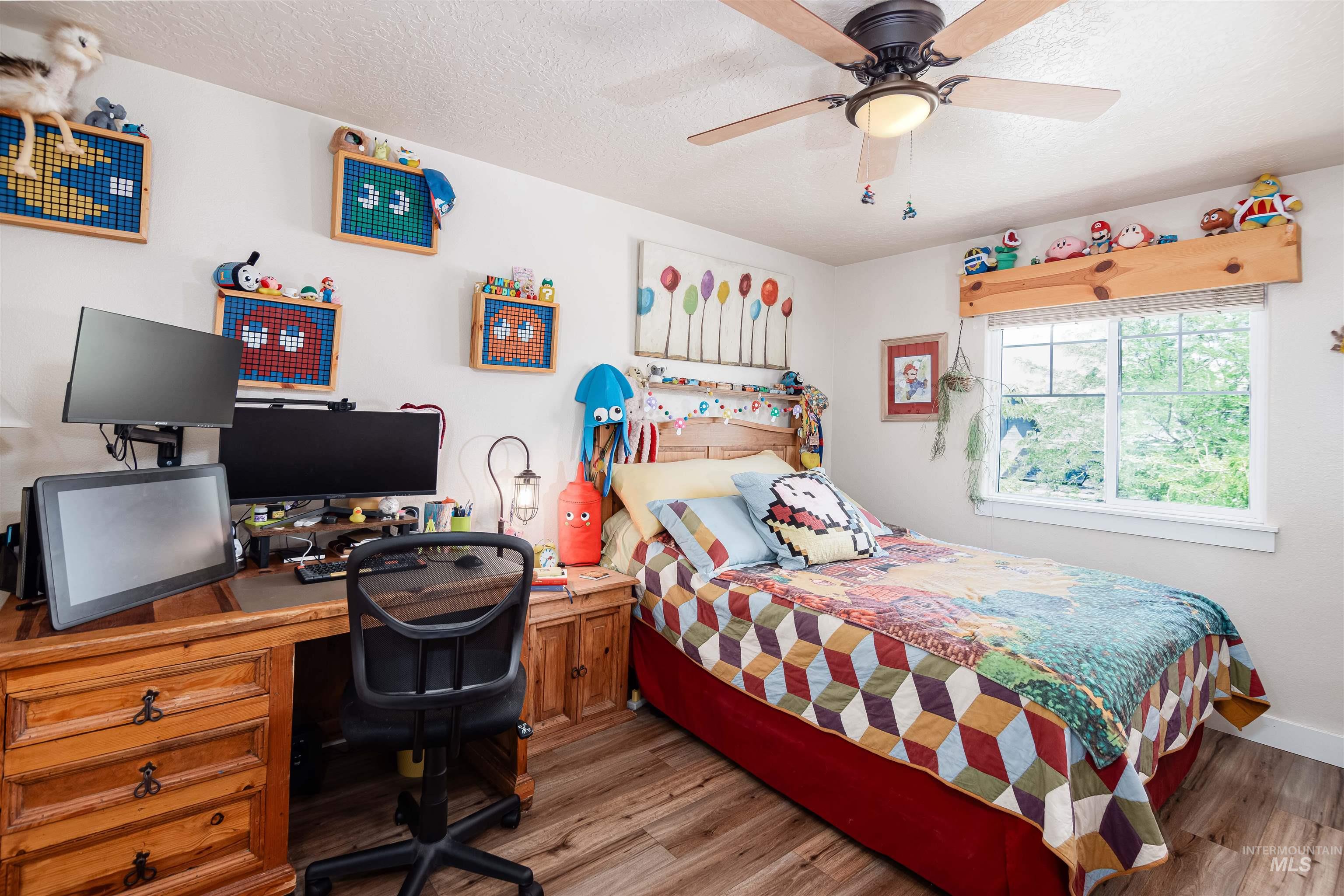 Warm-toned wood-finish flooring complements white walls