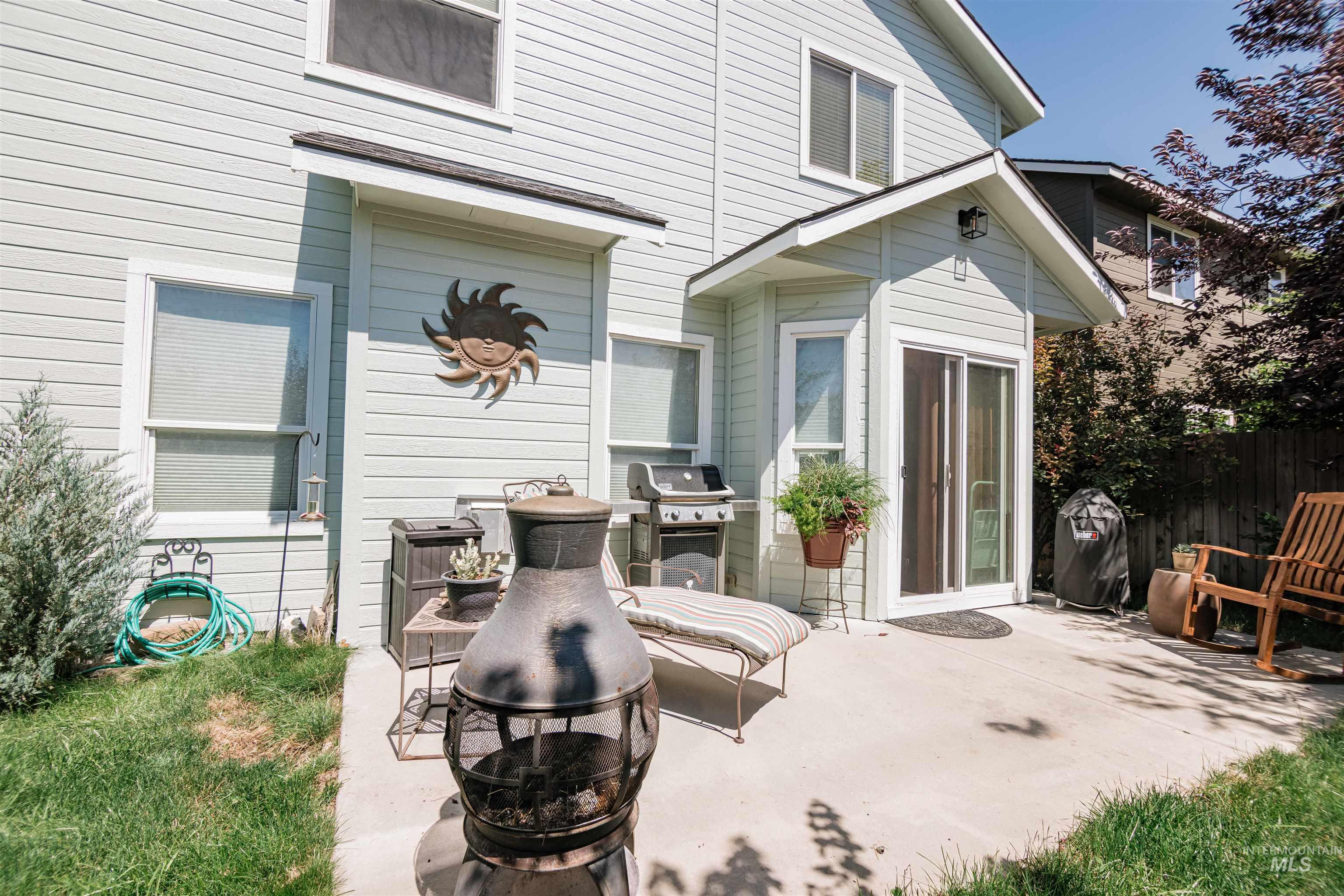 Rear exterior of the property featuring horizontal siding and a concrete patio
