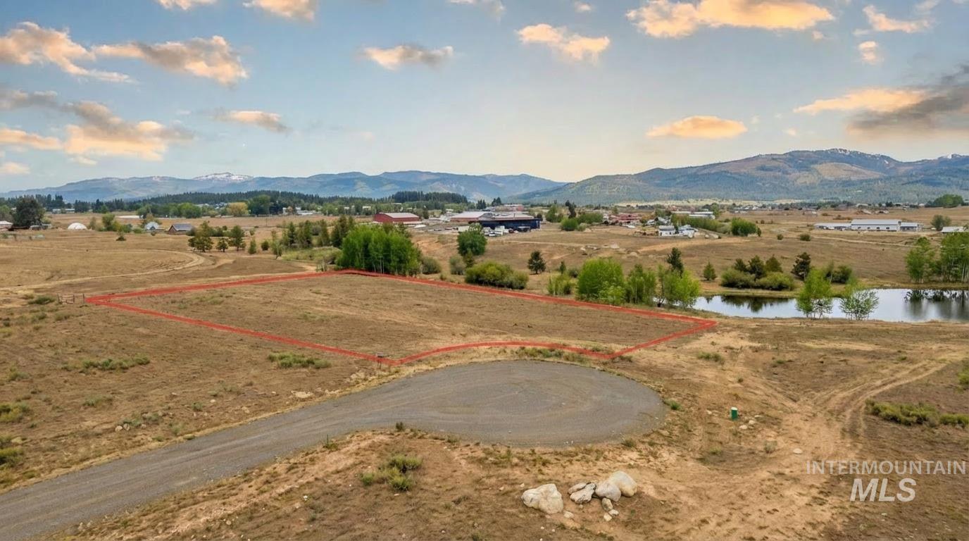 Overview of rural landscape with property boundaries highlighted and a water and mountain view