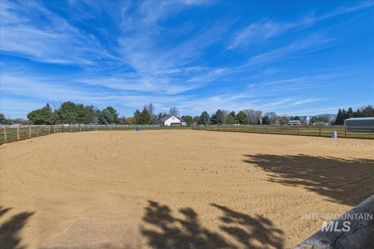 View of property's community with an outdoor riding arena and a view of countryside