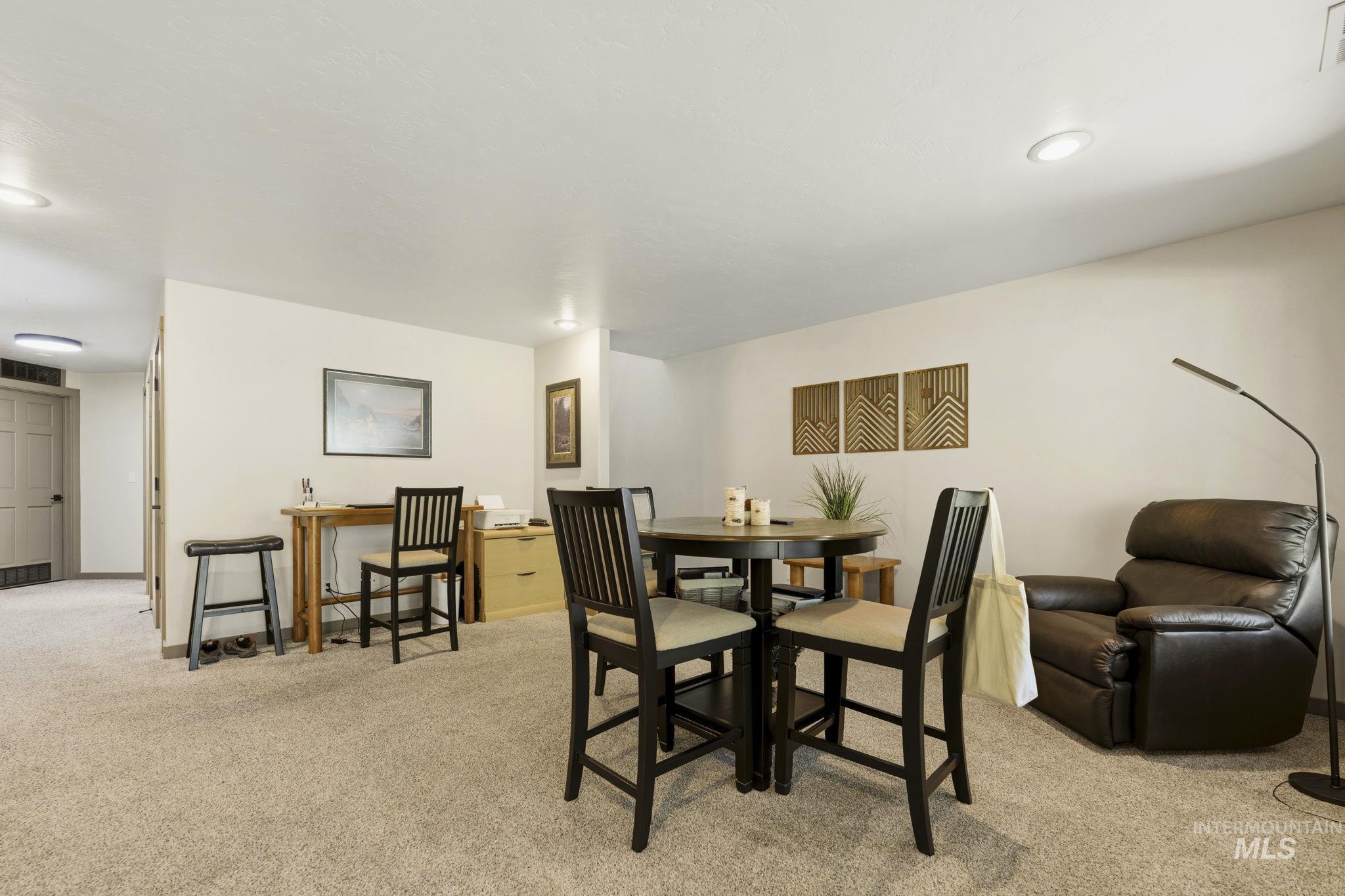 Spacious carpeted room featuring recessed lighting and a neutral color palette