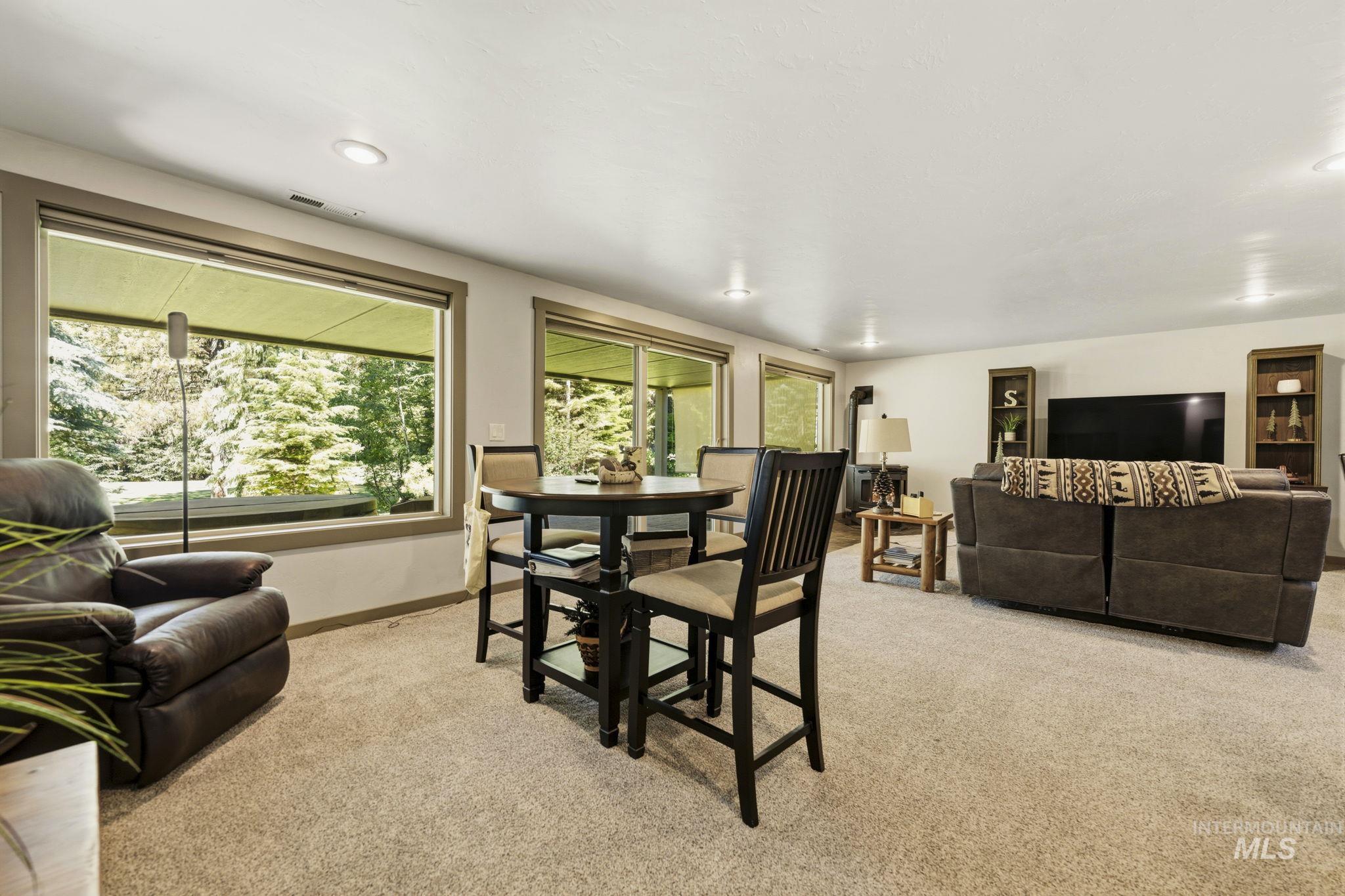Spacious room featuring broad windows, recessed lighting, and light-toned carpeting throughout