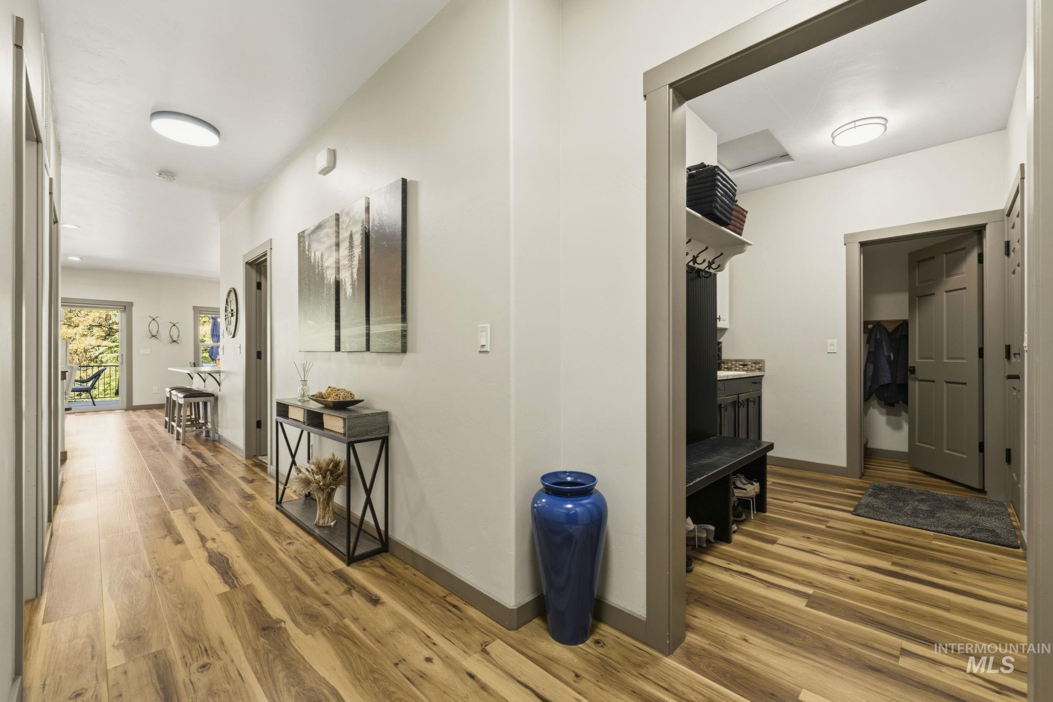 Spacious entryway featuring wood-finish flooring and neutral wall tones
