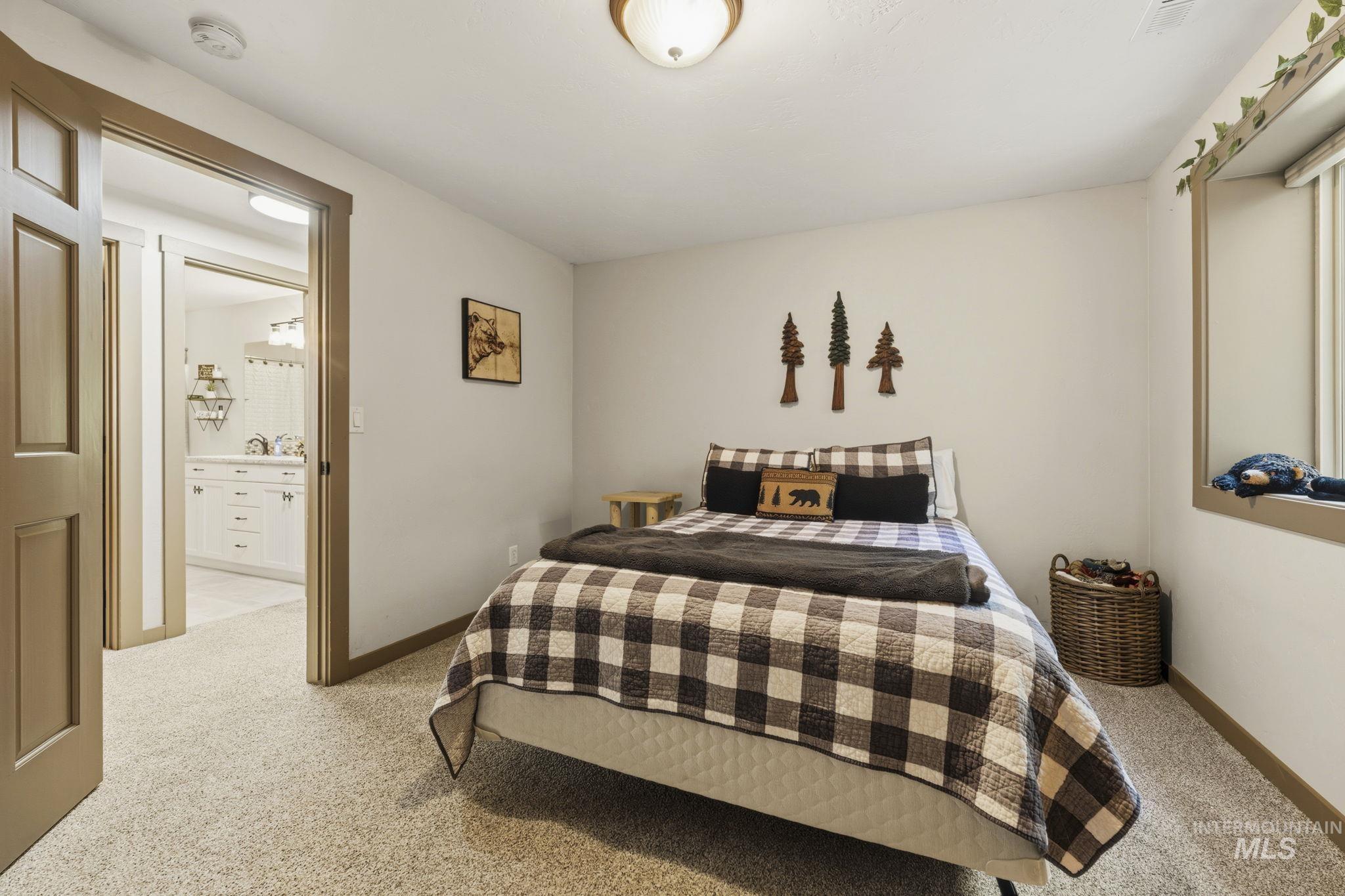 Carpeted interior room featuring a light-colored wall, a window with a deep sill, and a flush-mount ceiling light fixture