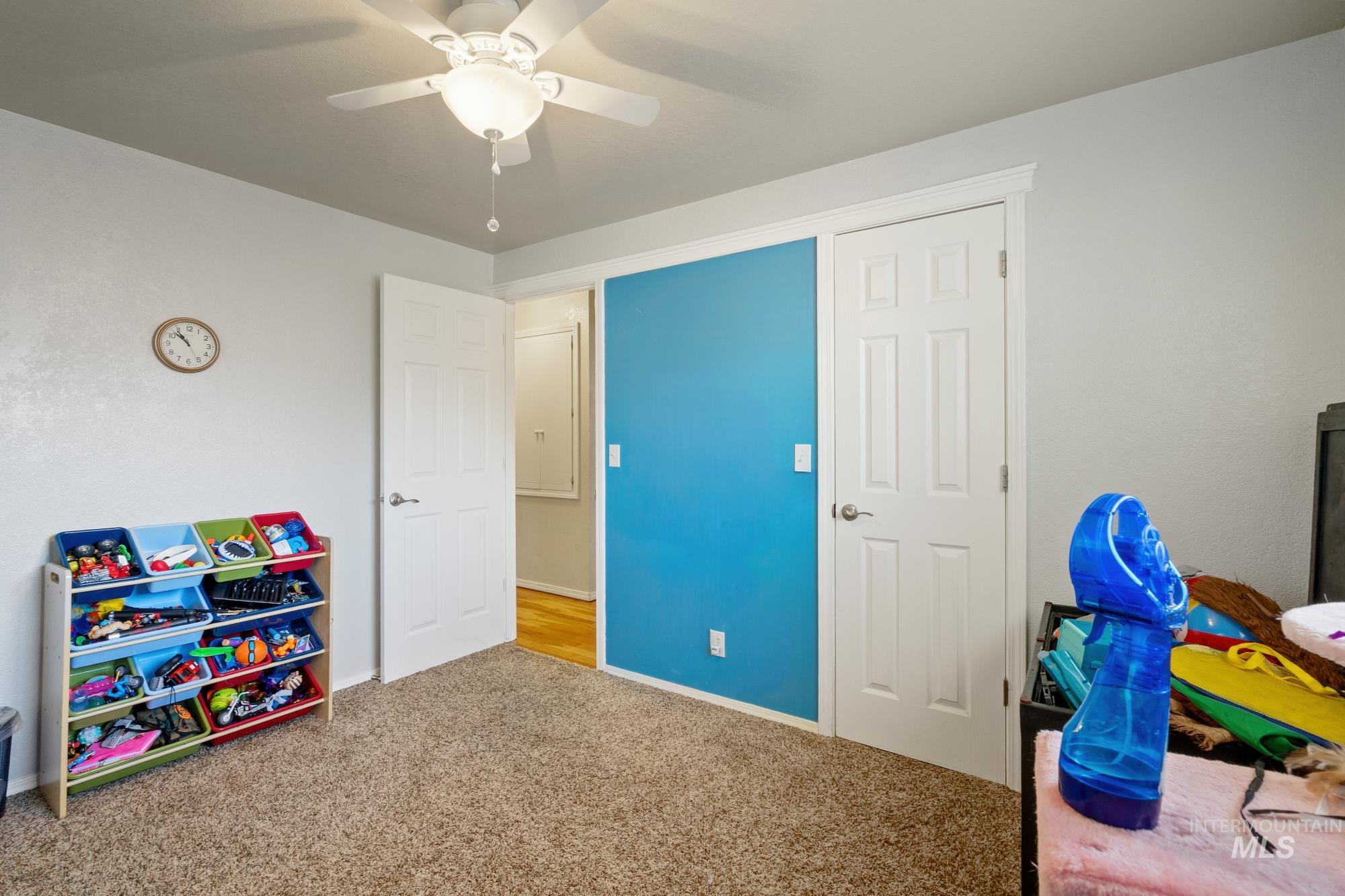 Game room with carpet floors and ceiling fan