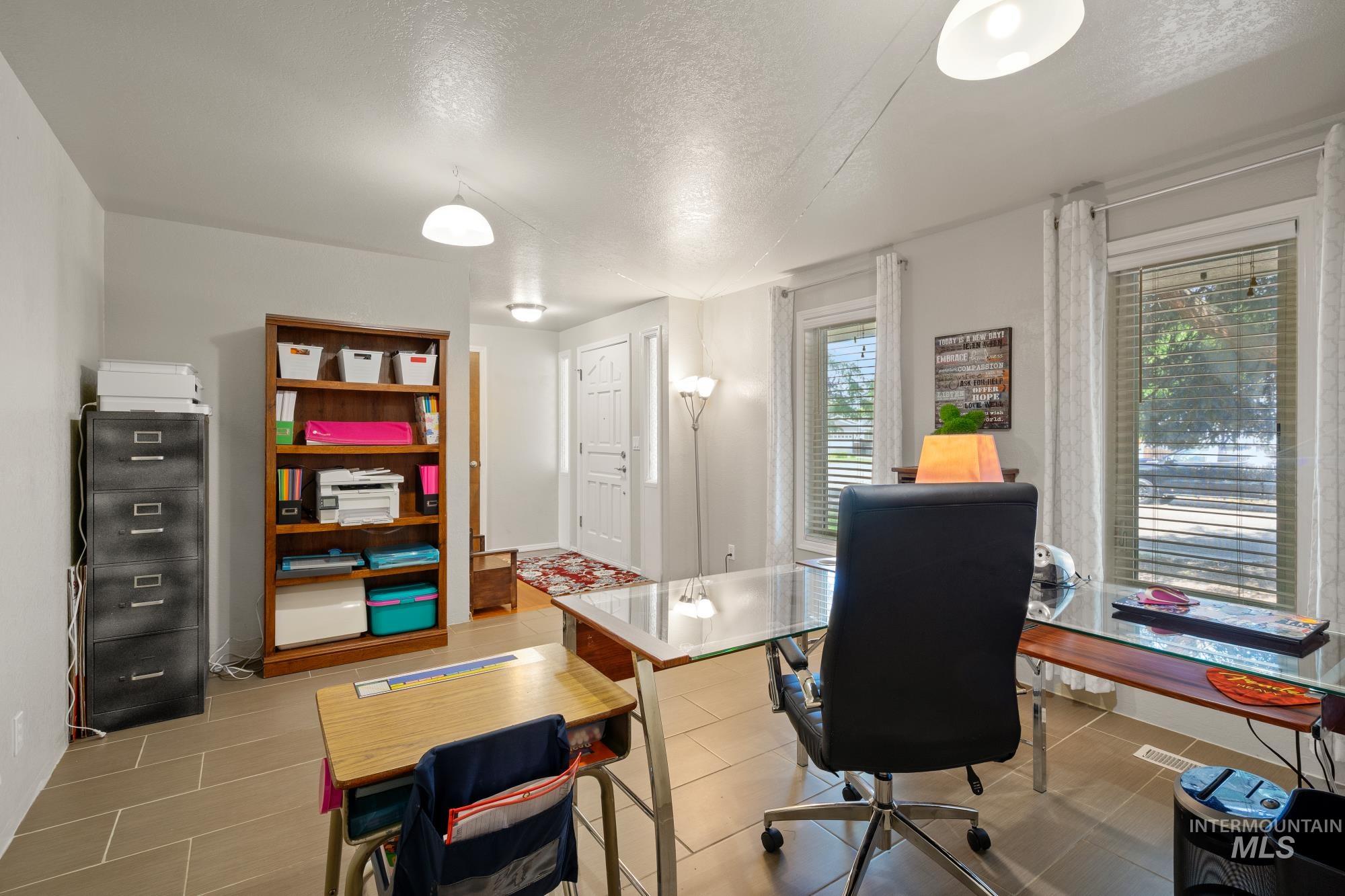 Tiled office featuring a textured ceiling