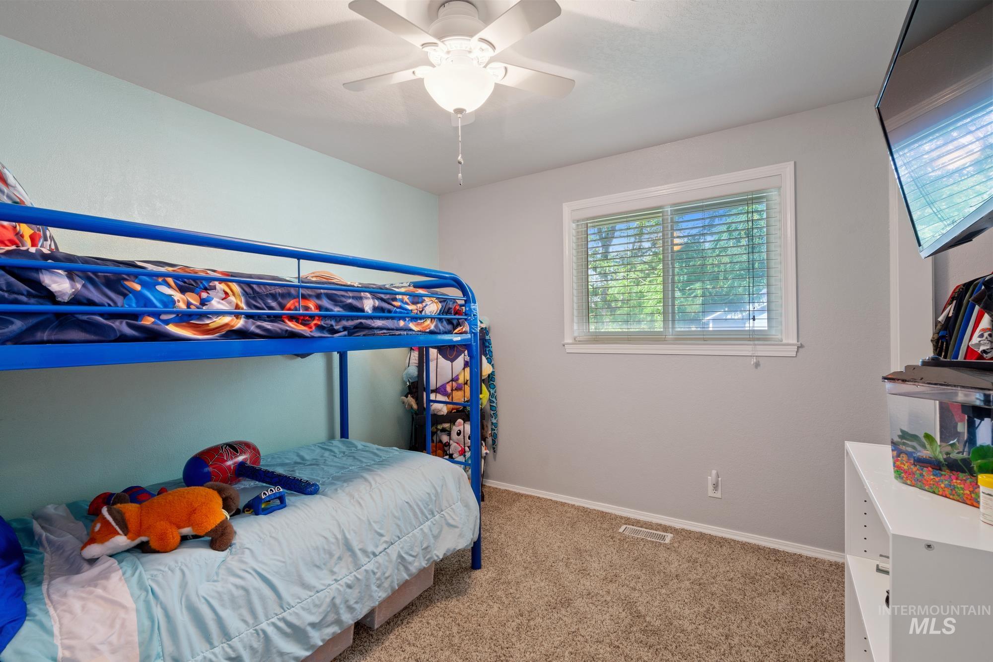 Bedroom featuring carpet and ceiling fan