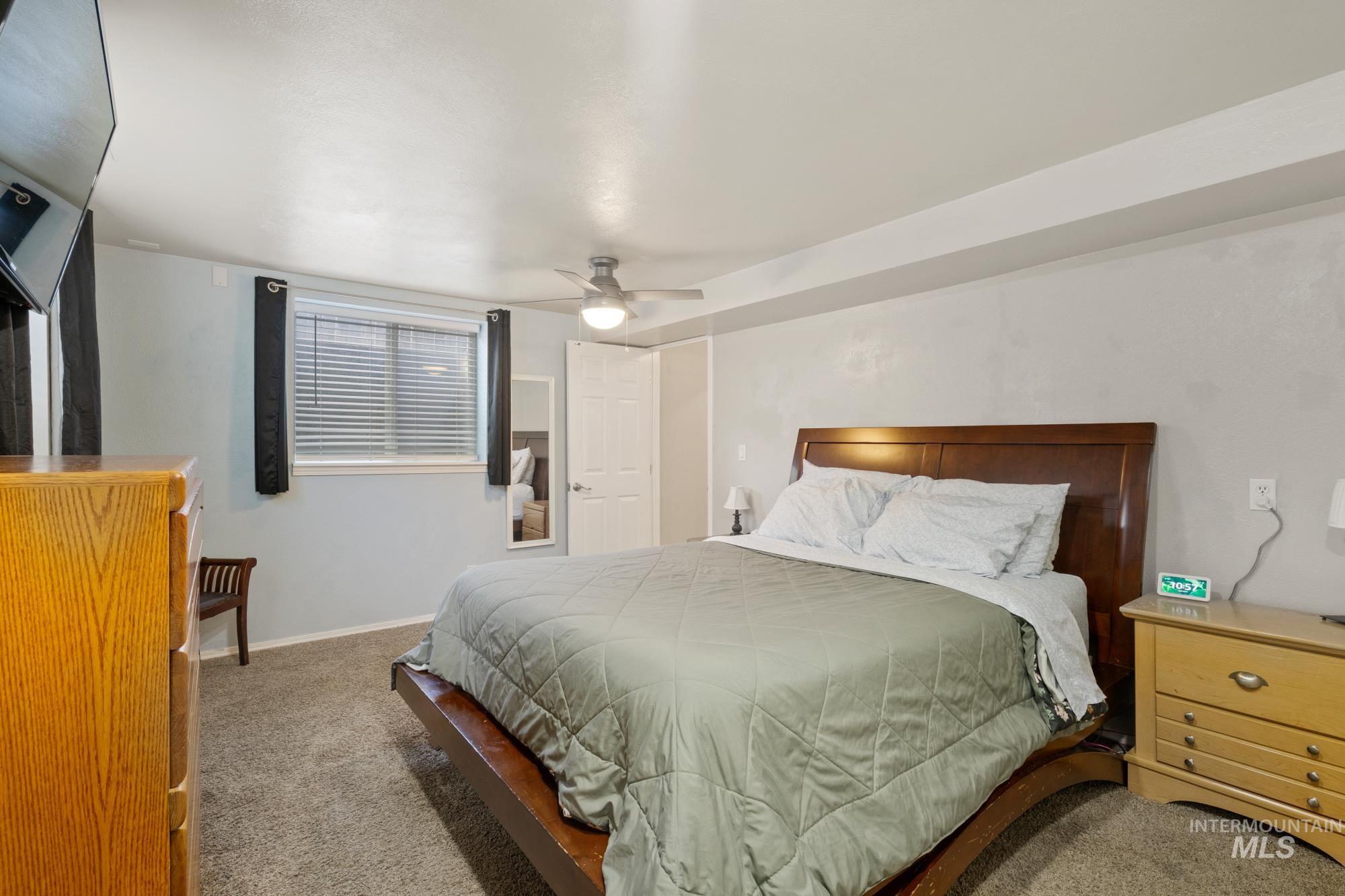 Bedroom with carpet flooring and a ceiling fan