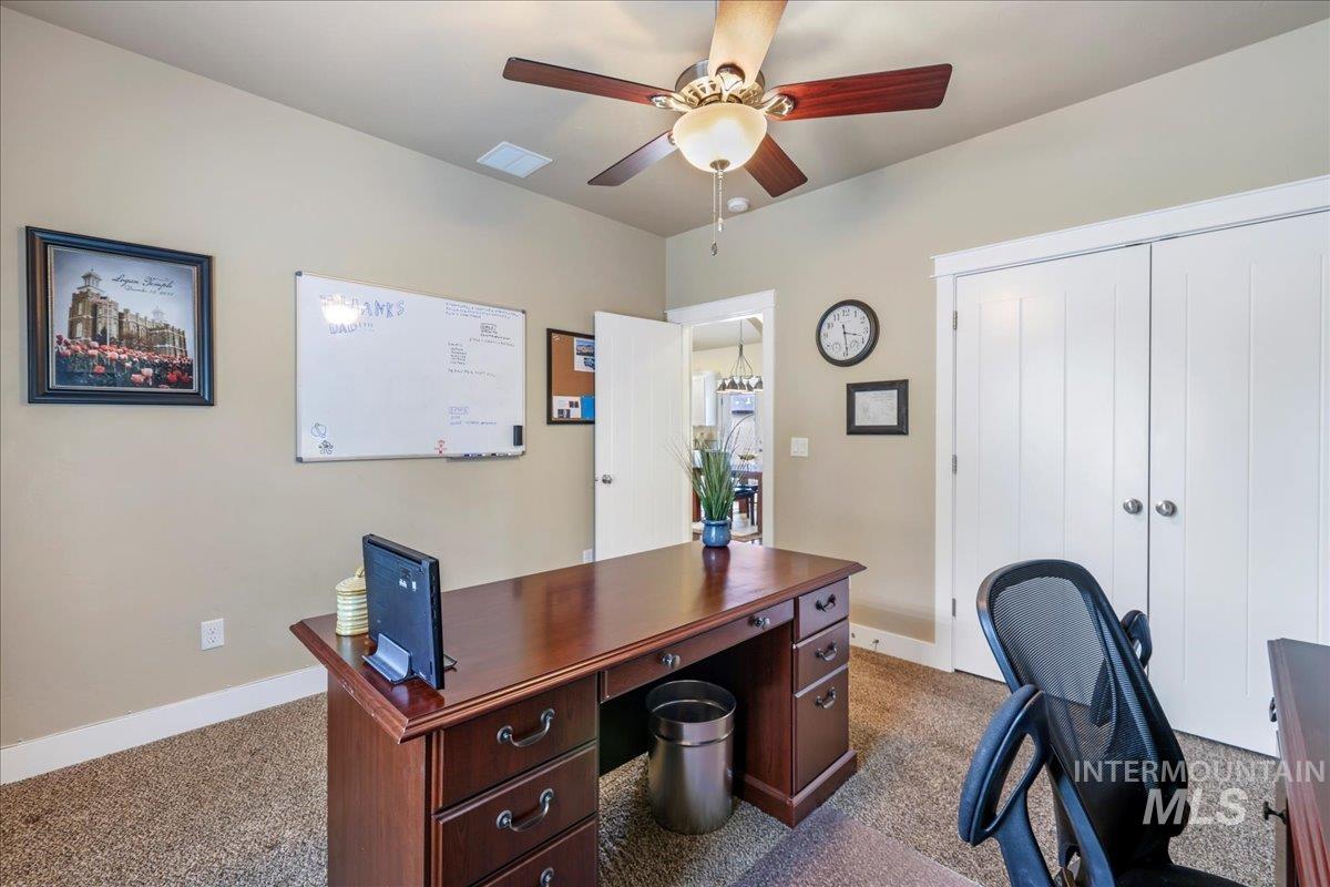 Office space featuring ceiling fan and carpet