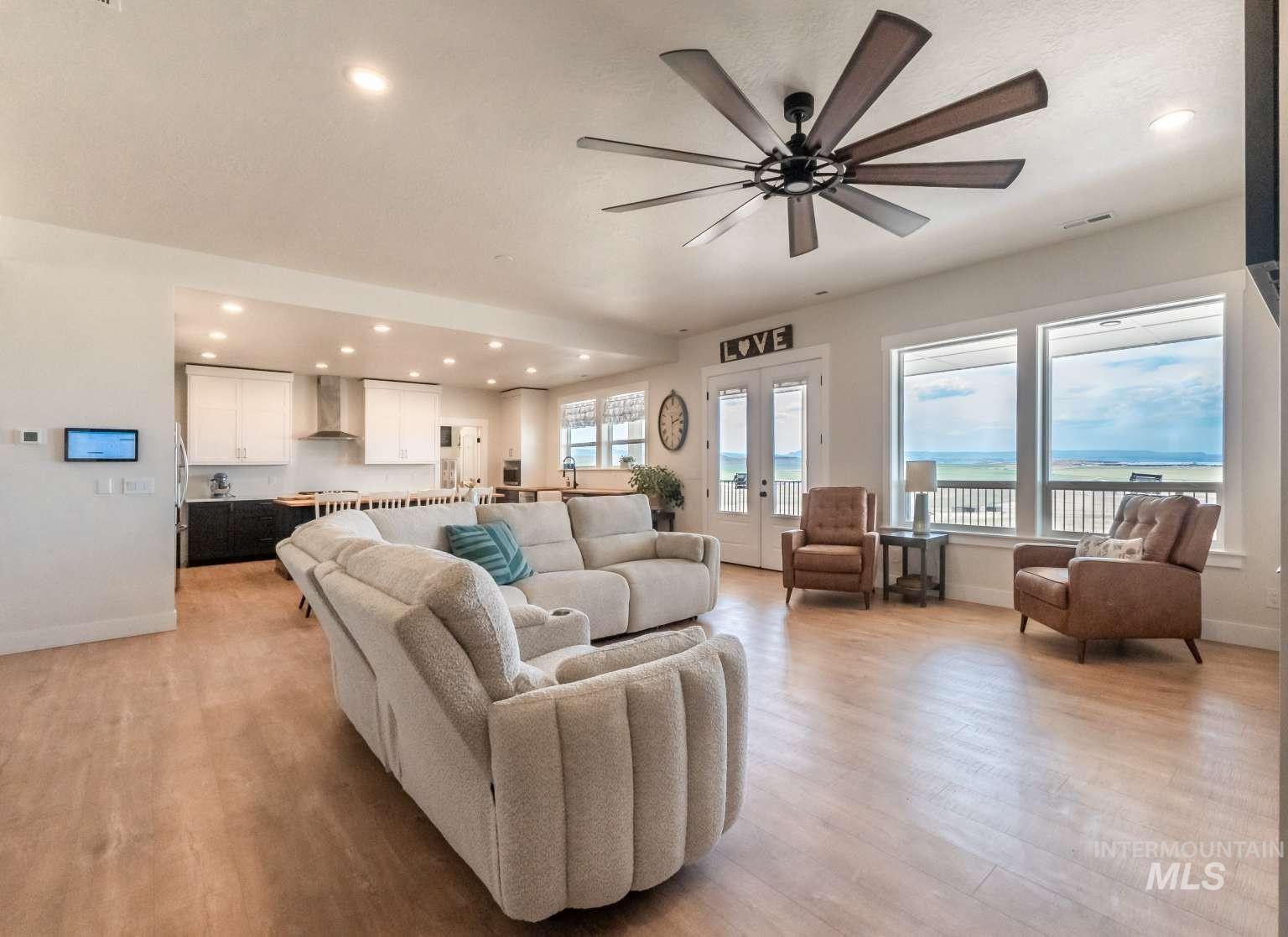 Living room featuring recessed lighting, light wood-style floors, ceiling fan, and french doors